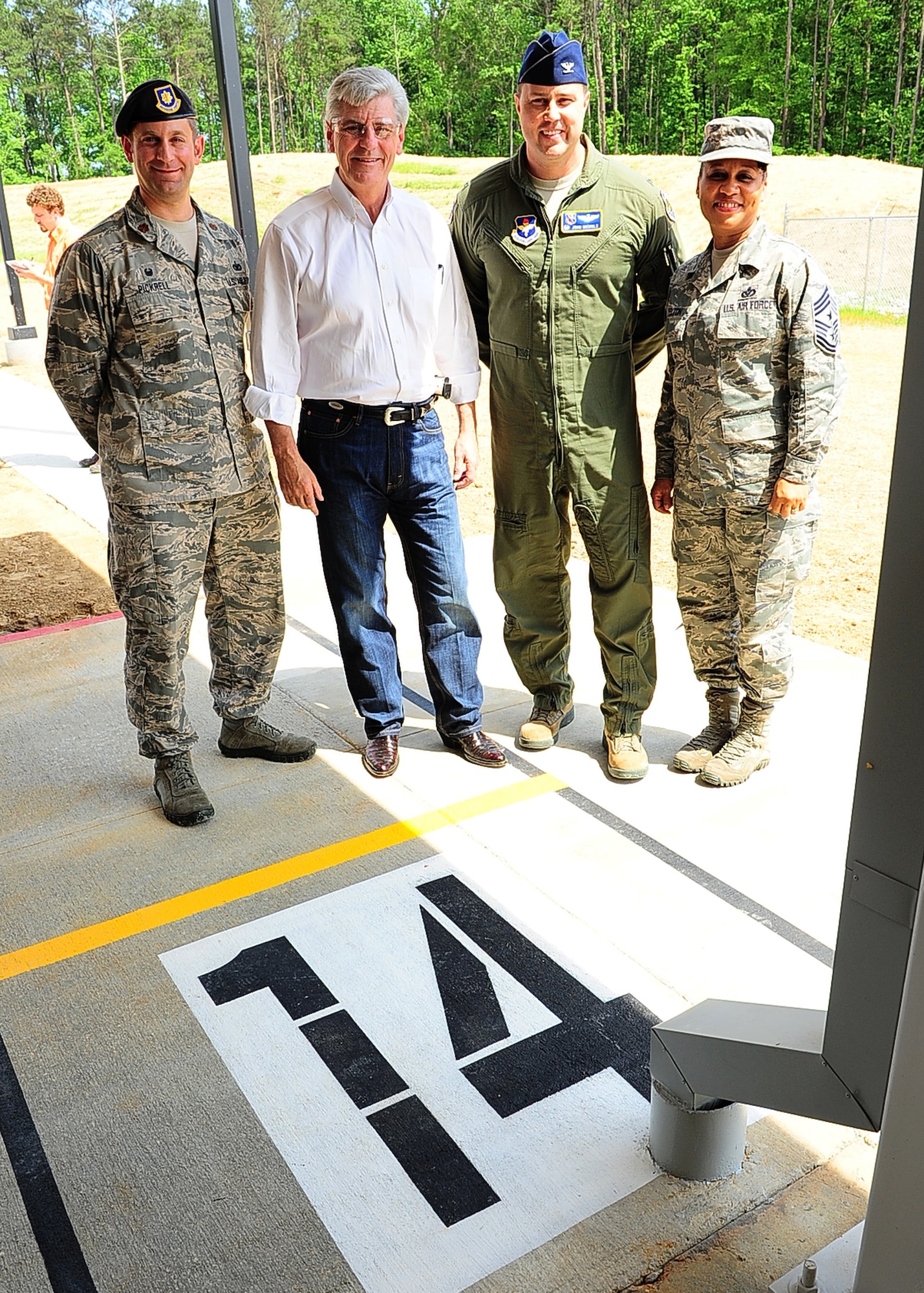 Maj. Brenton Pickrell, 14th Security Forces Squadron Commander, Mississippi Governor Phil Bryant, Col. John Nichols, 14th Flying Training Wing Commander, and Chief Master Sgt. Rita Felton, 14th FTW Command Chief, gather for a photo at Lane 14 of the new Columbus Lowndes County Small Arms Range May 8 in Lowndes County, Mississippi. The range will be used jointly by Columbus Air Force Base Airmen, Lowndes County, city of Columbus and other local law enforcement departments for weapons qualification and training. (U.S. Air Force photo/Airman Daniel Lile)