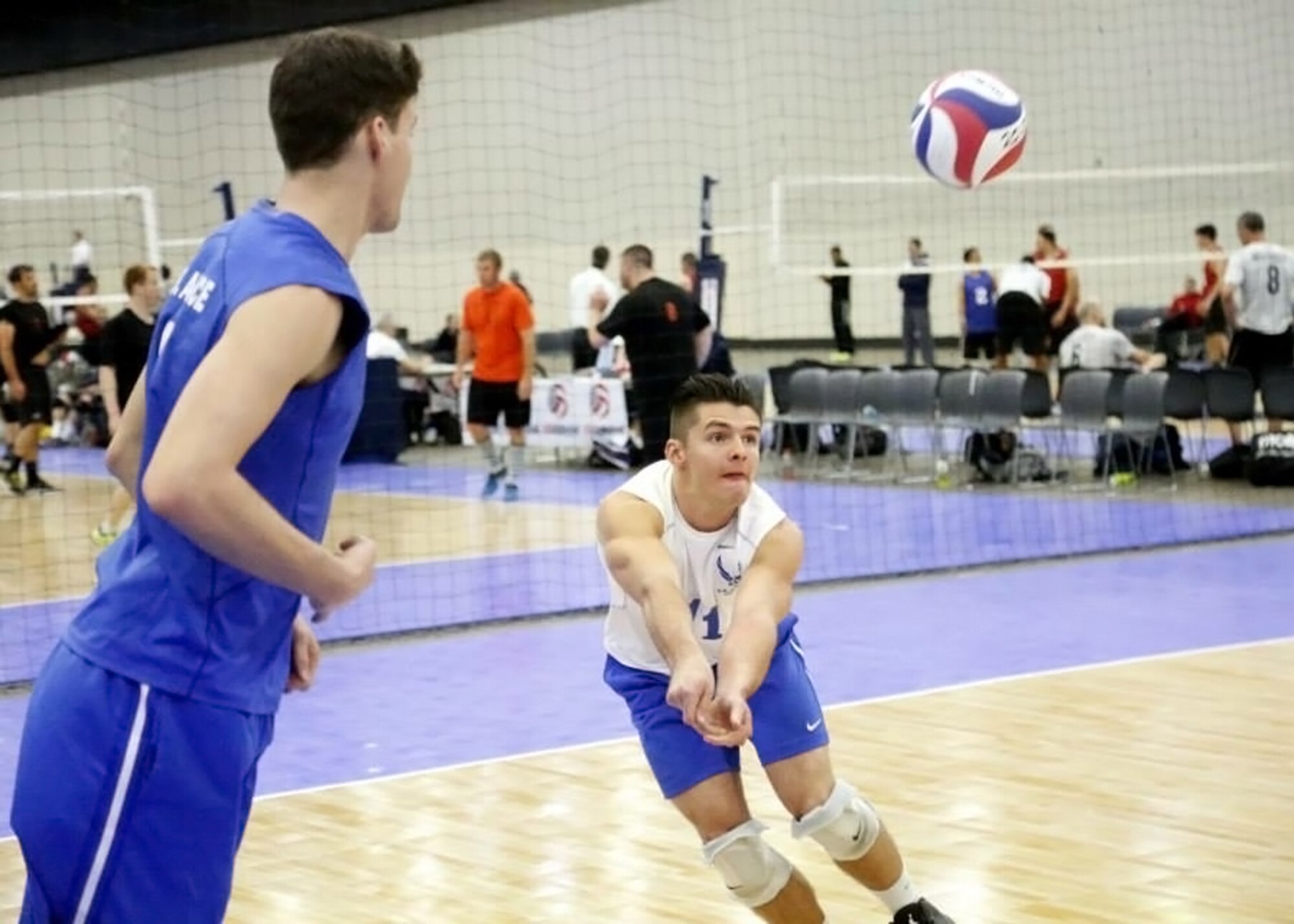 Senior Airman Evan LaRochelle, #11, passes the ball for the 2015 Air Force Men's Volleyball team during the USA Volleyball Open National Championships held in Detroit, Michigan, May 22 through 27. The Air Force Men’s Volleyball team won the gold medal in the All-Armed Forces Championship and they finished in 10th place overall. LaRochelle is a weapons load team member for the 412th Aircraft Maintenance Squadron at Edwards Air Force Base, Calif. (Courtesy photo)