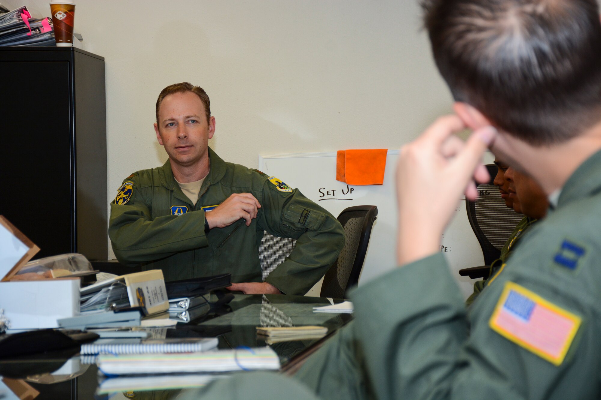 TRAVIS AIR FORCE BASE, Calif. -- Maj. Michael Pettibone, 301st Airlift Squadron, conducts a pre-flight brief to the aircrew June 6, 2015 prior to the flight that would transport Army troops and cargo to Ft. Hunter Liggett, Calif. The 301st AS provided airlift in a C-17 Globemaster III  as part of the 349th Air Mobility Wing's Air Force Specialty Code training. More than 70 California Army Guardsmen, four humvees and one truck were transported from Mather Air Force Base to Fort Hunter Liggett as part of the earthquake exercise scenario. (U.S. Air Force photo/Senior Airman Madelyn Brown)