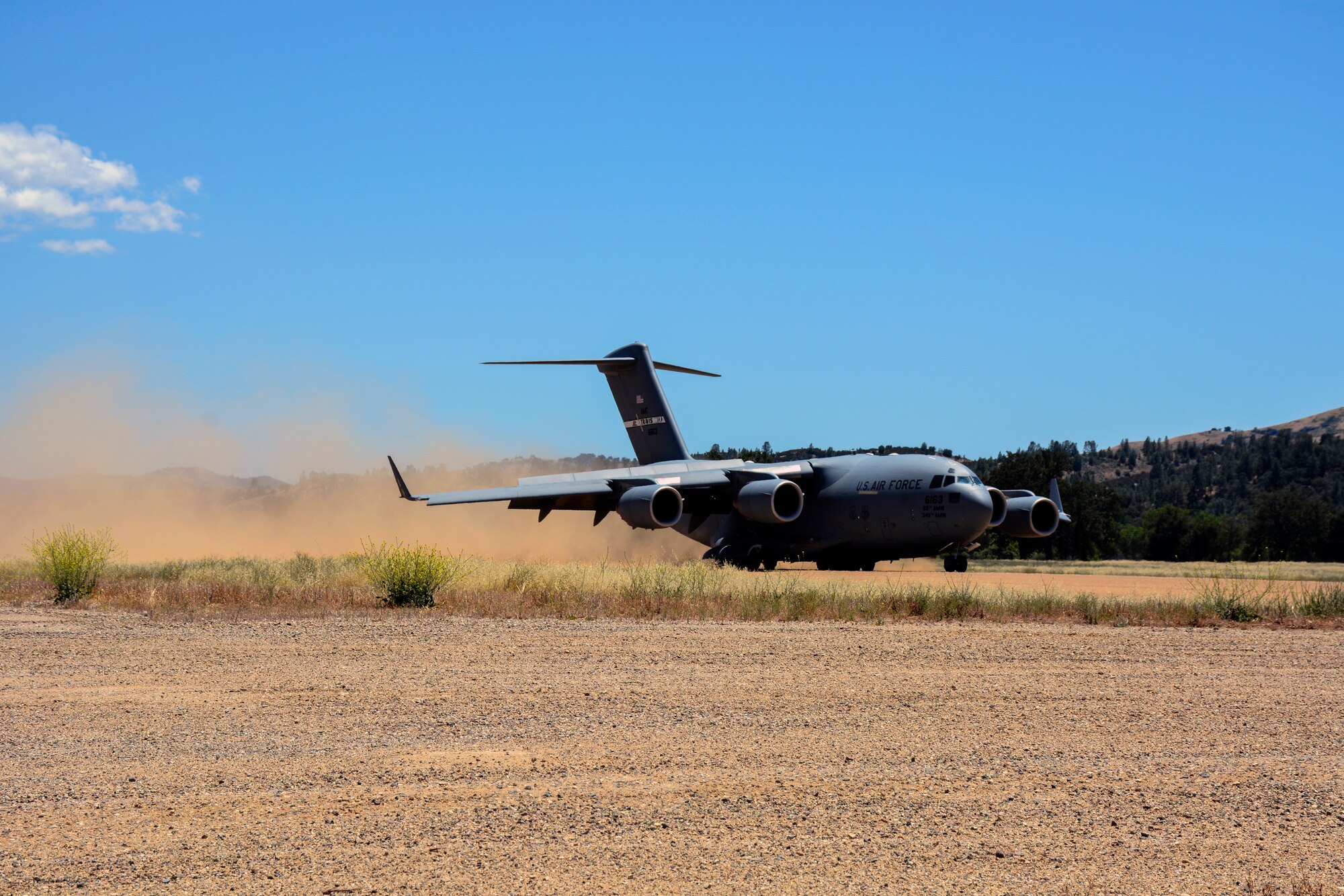 TRAVIS AIR FORCE BASE, Calif. -- The 301st Airlift Squadron provided airlift in a C-17 Globemaster III June 6, 2015 for more than 70 California Army Guardsmen, four humvees and one truck from Mather Air Force Base, Calif. to Ft. Hunter Liggett, Calif. as part of an earthquake exercise during Air Force Specialty Code training.The overall exercise provided a seamless integrated training experience for Air Force Reservists, active duty and Army National Guard service members. (U.S. Air Force photo/Senior Airman Madelyn Brown)