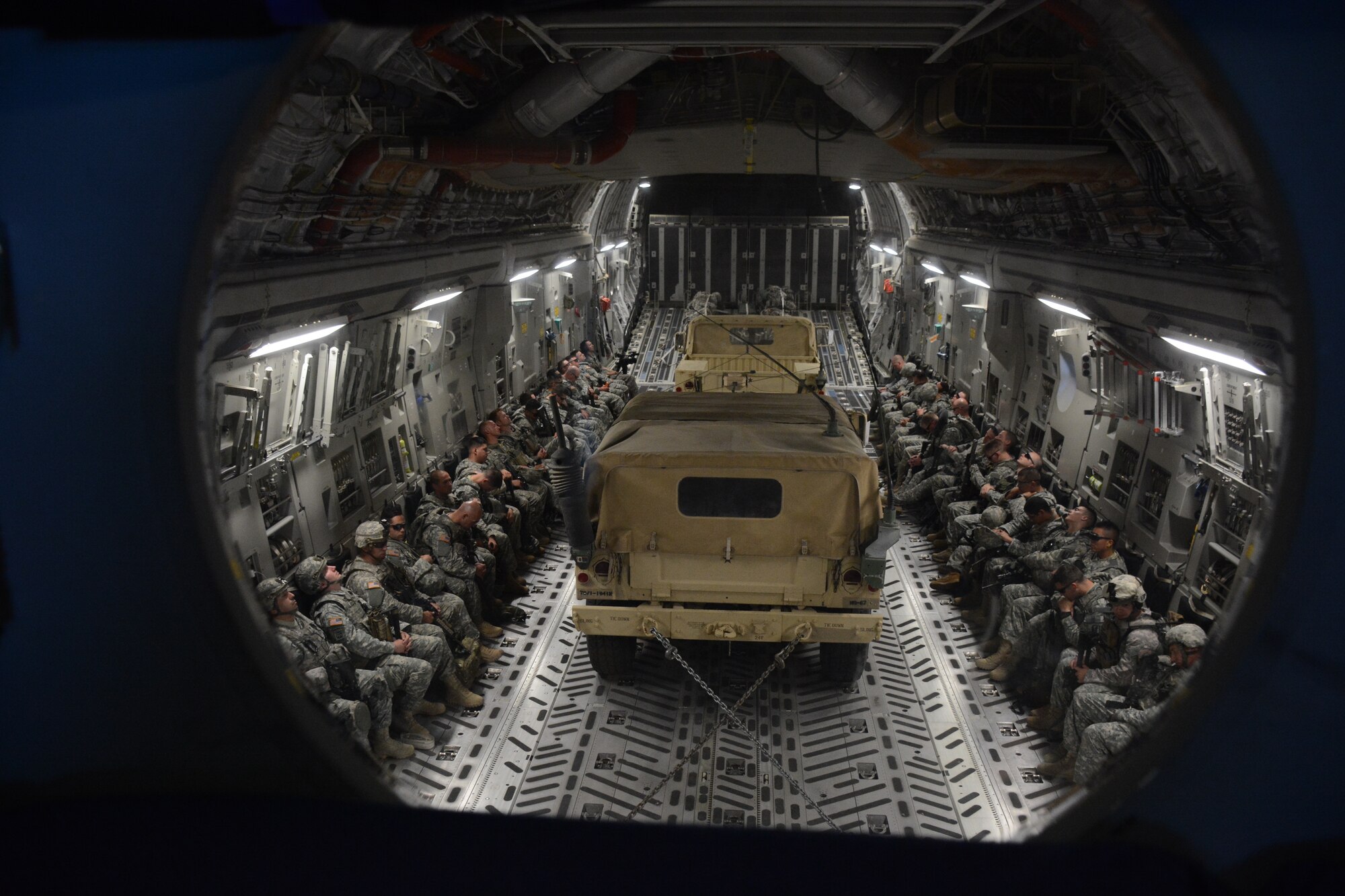 TRAVIS AIR FORCE BASE, Calif. -- The 301st Airlift Squadron provided airlift in a C-17 Globemaster III June 6, 2015 for more than 70 California Army Guardsmen, four humvees and one truck from Mather Air Force Base, Calif. to Ft. Hunter Liggett, Calif. as part of an earthquake exercise during Air Force Specialty Code training.The overall exercise provided a seamless integrated training experience for Air Force Reservists, active duty and Army National Guard service members. (U.S. Air Force photo/Senior Airman Madelyn Brown)