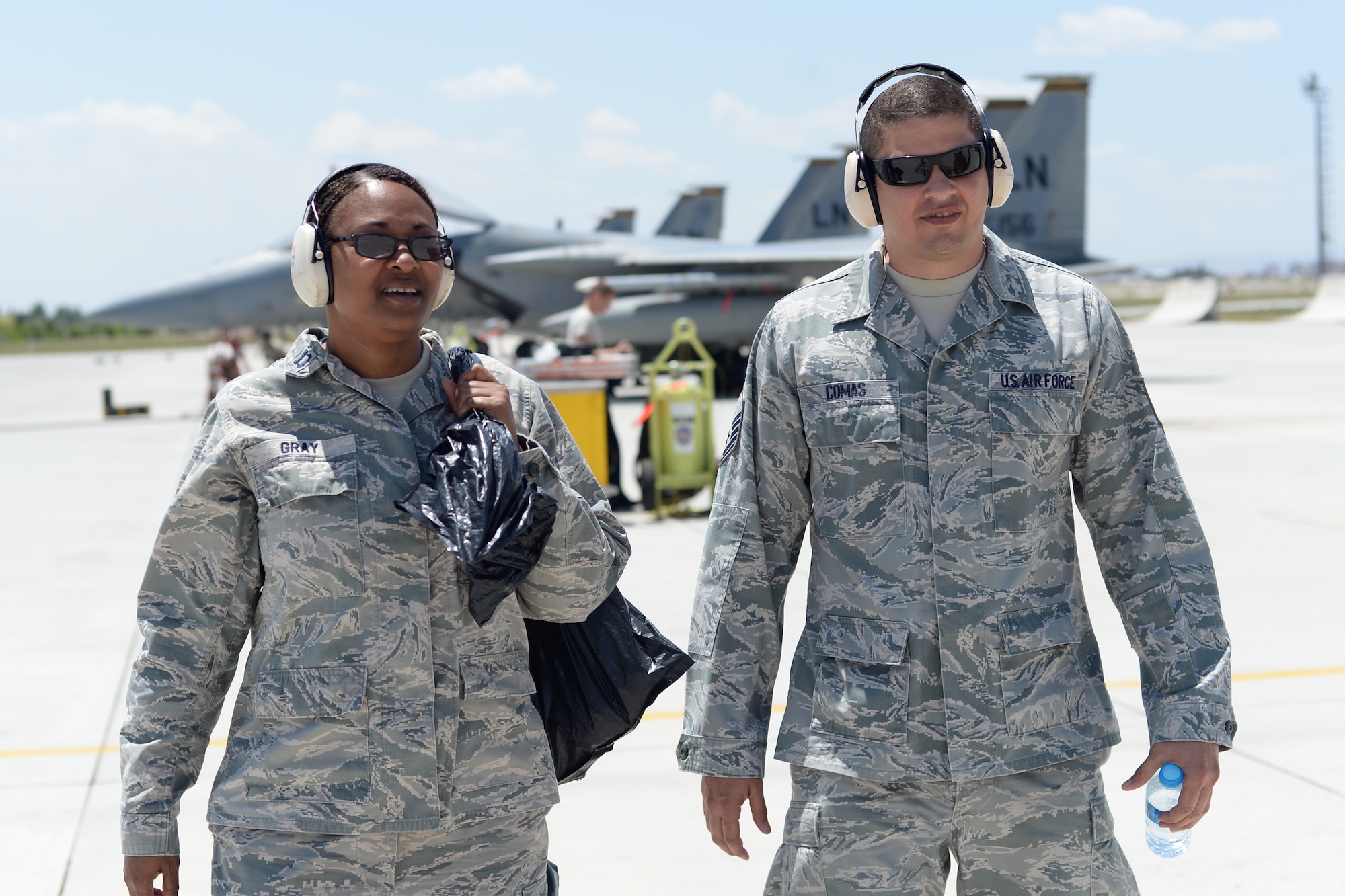 : U.S. Air Force Chaplain (Capt.) Kenya Gray, 48th Fighter Wing, left, and Master Sgt. Carlos Comas, 48th FW chaplain assistant, walk along the 3rd Main Jet Base flightline, June 16, 2015, during Anatolian Eagle 15 in Konya, Turkey. During the exercise, Gray and Comas routinely visit with Airmen working around the flightline and other areas of the base. (U.S. Air Force photo by Tech. Sgt. Eric Burks/Released)