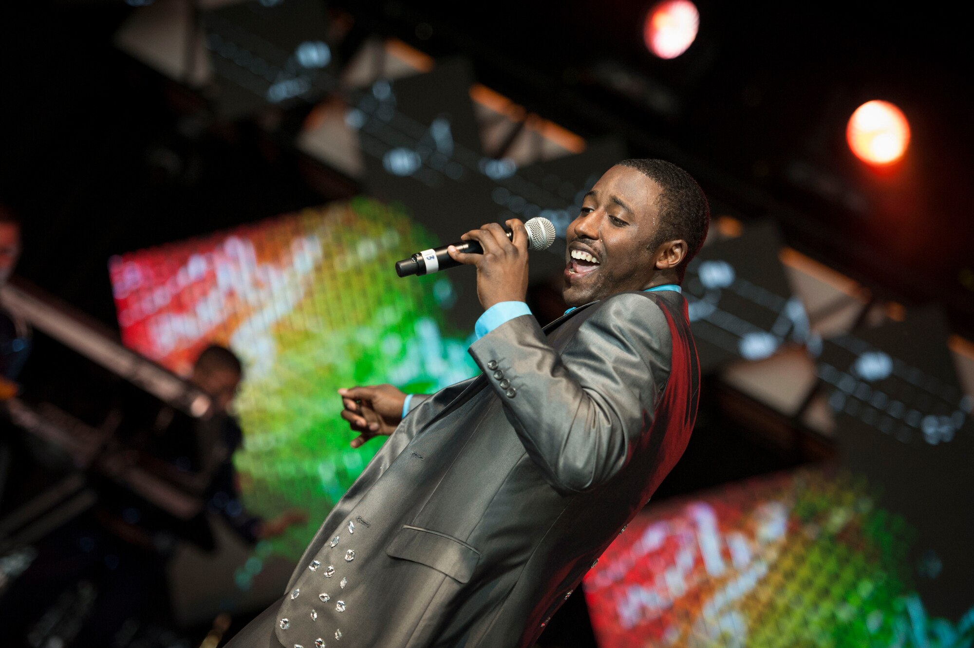 U.S. Air Force Airman 1st Class Mitchell Dixon, Tops in Blue performer, sings during a performance June 12, 2015, at Wild Adventures in Valdosta, Ga. Dixon is an aerospace propulsion journeyman from the 4th Component Maintenance Squadron at Seymour Johnson Air Force Base, N.C.  (U.S. Air Force photo by Andrea Jenkins/Released) 
