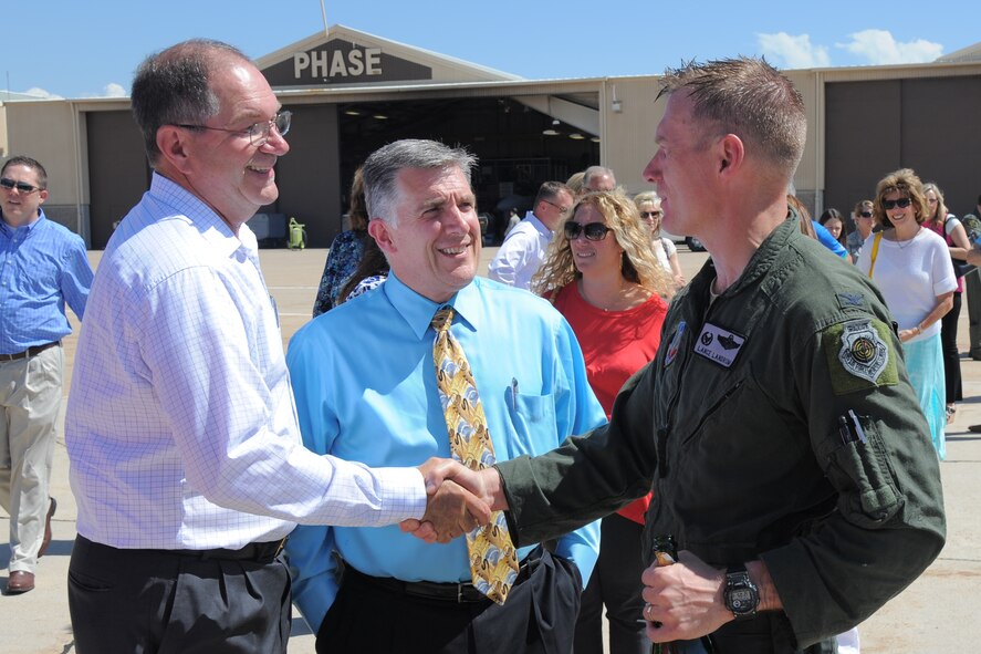 388th Fighter Wing Commander Col. Lance Landrum is greeted by 388th Fighter Wing Honorary Commanders after his fini flight here June 16. Layton Mayor Bob Stevenson and Clearfield Mayor Mark Shepherd and more than 40 more local civic leaders and distinguished guests came to celebrate Landrum's final ride in an F-16. (U.S. Air Force photo by Todd Cromar) 