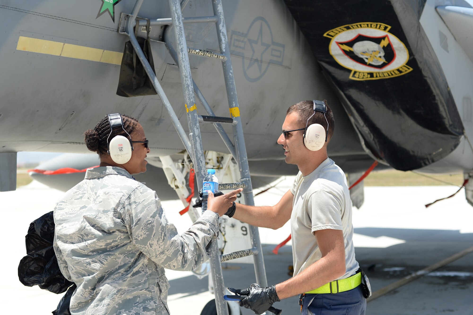 U.S. Air Force Chaplain (Capt.) Kenya Gray, 48th Fighter Wing, delivers cold bottled water to 48th FW Airmen, June 16, 2015, during Anatolian Eagle 15 at 3rd Main Jet Base, Konya, Turkey. Chaplain Gray is one of about 250 personnel from the 48th Fighter Wing, Royal Air Force Lakenheath, England, participating in Anatolian Eagle. (U.S. Air Force photo by Tech. Sgt. Eric Burks/Released)