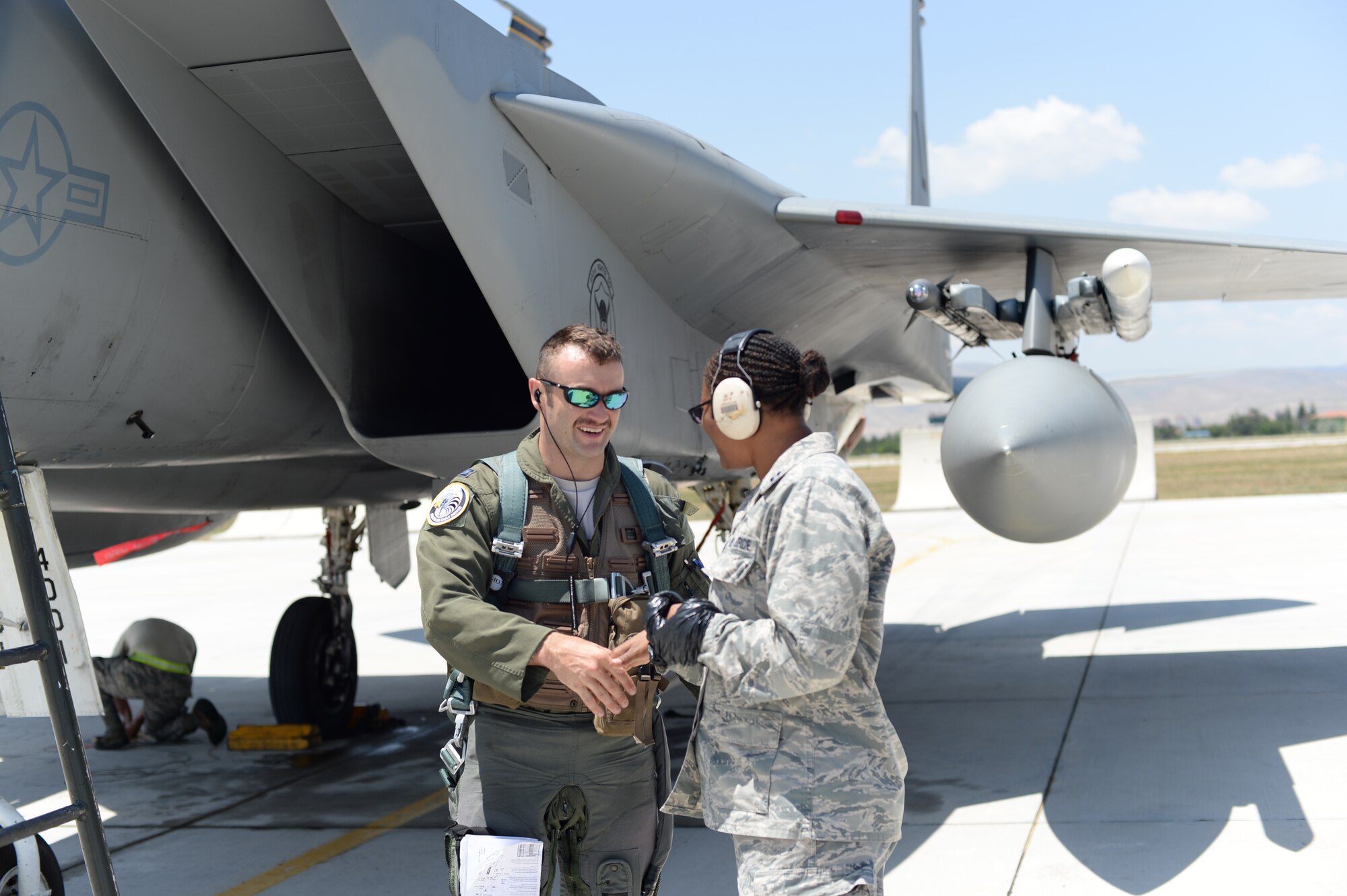U.S. Air Force Chaplain (Capt.) Kenya Gray, 48th Fighter Wing, right, shakes hands with Capt. Jason Ford, 493rd Fighter Squadron pilot, June 16, 2015, during Anatolian Eagle 15 at 3rd Main Jet Base, Konya, Turkey. Throughout the exercise, Gray has routinely visited Airmen working around the flightline and other areas of the base. (U.S. Air Force photo by Tech. Sgt. Eric Burks/Released)