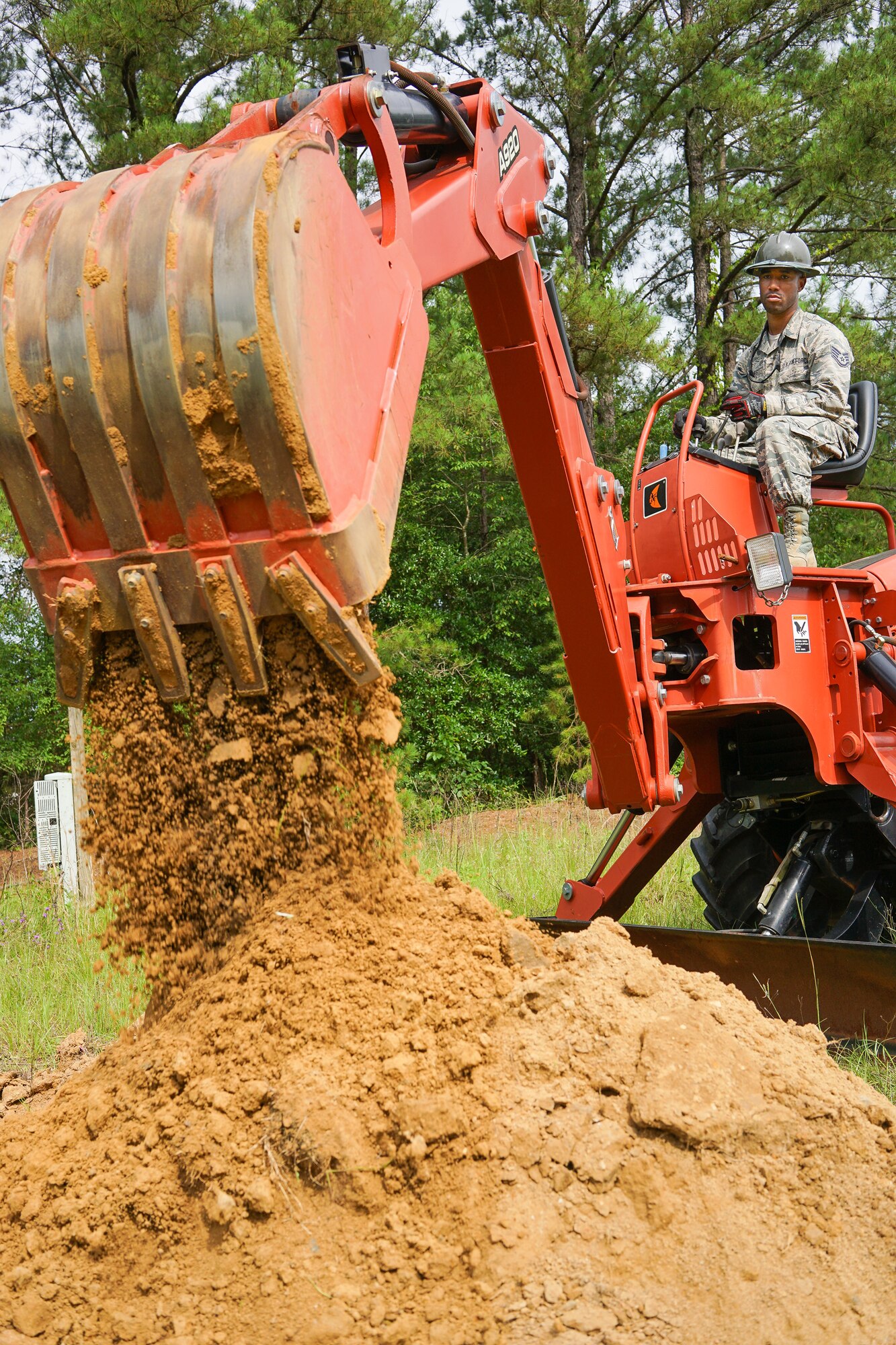 U.S. Air Force Staff Sgt. Joseph Jones, a cable and antenna systems specialist with the 202nd Engineering Installation Squadron (EIS), Georgia Air National Guard, digs a trench using a trencher with a backhoe attachment during a weeklong training exercise at Robins Air Force Base, Ga., June 11, 2015. More than 80 Airmen were certified in career-field tasks crucial to the unit’s deployed and homeland missions. The 202nd EIS supports the 116th Air Control Wing and is responsible for the fixed-communications infrastructures for 27 other locations, including the 165th Airlift Wing in Savannah, Georgia, and Air National Guard units in Puerto Rico and the U.S. Virgin Islands. (U.S. Air National Guard photo by Senior Master Sgt. Roger Parsons/Released)
