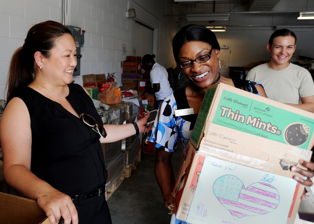Cain Delphine, Smart Building event planner, carries out two cases of Girl Scout Cookies during Operation Cookie Drop at the Jones Building on Joint Base Andrews, Md., June 16.  Thousands of boxes were donated to JBA service members and their families by Girl Scouts Heart of the Hudson Council. This is the second year JBA has received donations. (U.S. Air Force photo/Staff Sgt. Nichelle Anderson) 