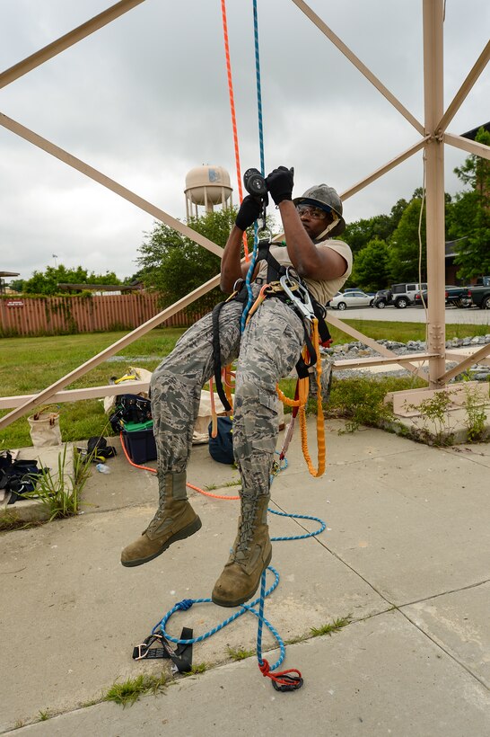 U.S. Air Force Staff Sgt. Lentrell Hill, a radio frequency transmission technician with the 202nd Engineering Installation Squadron (EIS), Georgia Air National Guard, repels from a tower during a tower climbing and rescue training exercise being conducted during the unit’s annual training at Robins Air Force Base, Ga., June 10, 2015. The 202nd EIS’s enlisted and officer engineers, draftsmen, cable and electronics professionals design and install communications infrastructures. Some of their duties include building antennas, towers, fiber optics, and surveillance equipment, to access control and intrusion detection systems anywhere in the world. (U.S. Air National Guard photo by Senior Master Sgt. Roger Parsons/Released) 