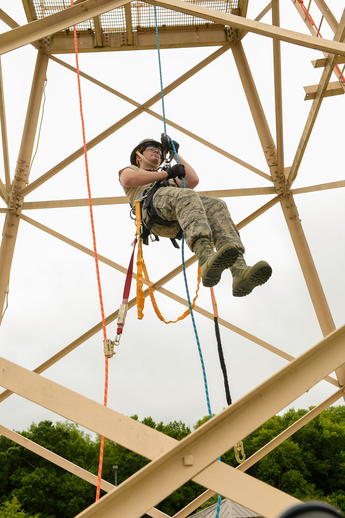 U.S. Air Force Airman 1st Class Justin Janes, an airfield systems apprentice with the 202nd Engineering Installation Squadron (EIS), Georgia Air National Guard, repels from a tower during a tower climbing and rescue training exercise being conducted during the unit’s annual training at Robins Air Force Base, Ga., June 10, 2015. The 202nd EIS’s enlisted and officer engineers, draftsmen, cable and electronics professionals design and install communications infrastructures. Some of their duties include building antennas, towers, fiber optics, and surveillance equipment, to access control and intrusion detection systems anywhere in the world. (U.S. Air National Guard photo by Senior Master Sgt. Roger Parsons/Released) 
