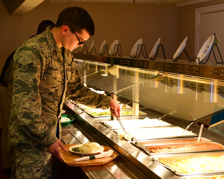 Airman 1st Class Jacob Brillhart, 2nd Aircraft Maintenance Squadron electronic warfare apprentice, selects lunch items from a buffet at the Barksdale Club on Barksdale Air Force Base, La., June 11, 2015. The Food Transformation Initiative provides Airmen with healthier options in addition to offering a variety of locations including the Barksdale Club, Bowling Alley, Fox Run Golf Course and others to meal card holders. (U.S. Air Force photo/Airman 1st Class Mozer O. Da Cunha)