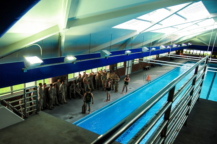 U.S. Marines from the 3rd Battalion, 8th Marine Regiment and the 26th Marine Expeditionary Unit receive a safety brief prior to conducting USMC Water Survival Training, June 10, 2015, at Camp Lejeune, North Carolina. The training program ensures combat readiness by equipping Marines to survive a waterborne mishap. (U.S. Air Force photo/Senior Airman Brittain Crolley)