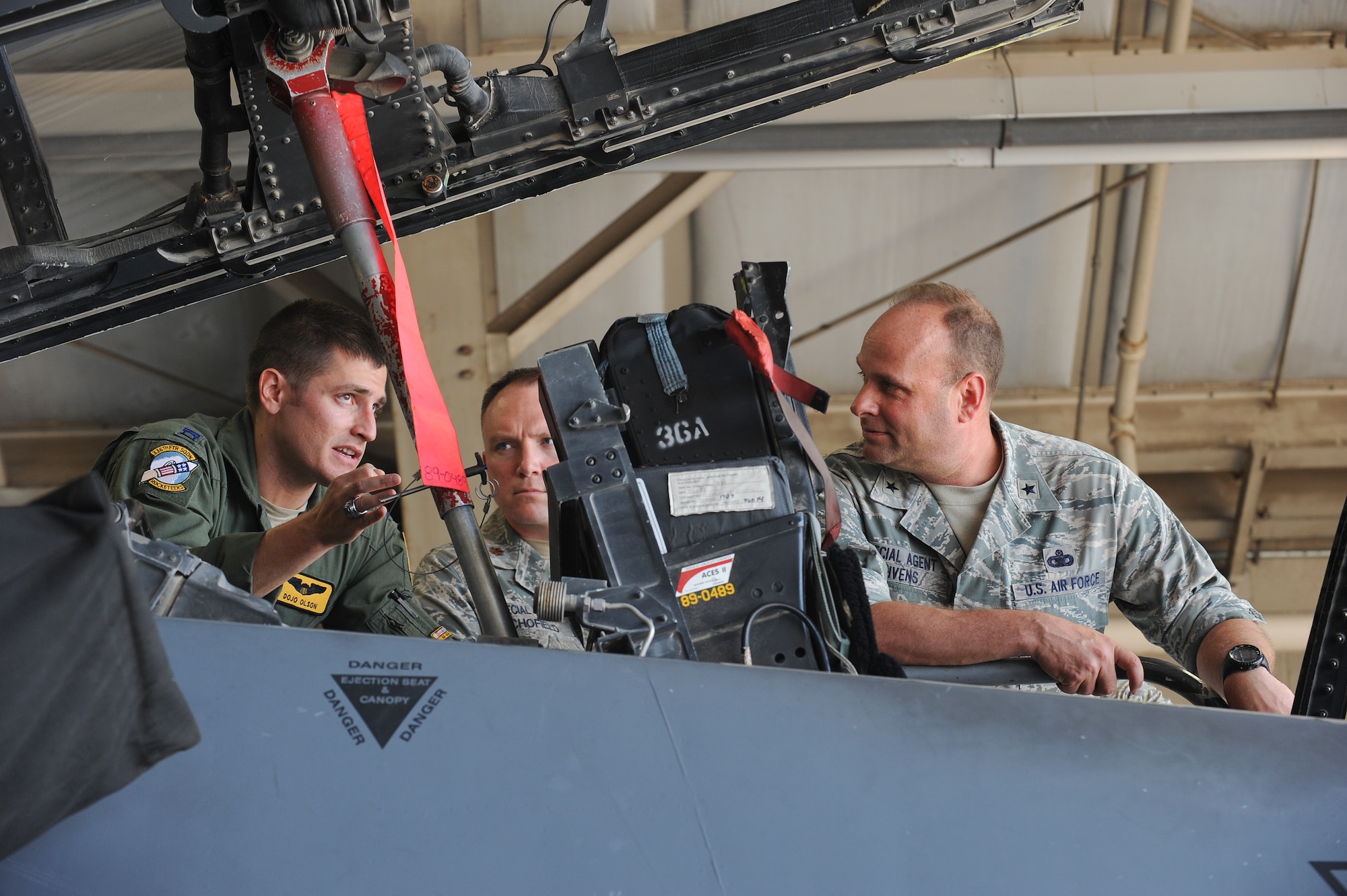 Capt. Andrew Olson, 336th Fighter Squadron pilot, explains components of the F-15E Strike Eagle to Brig. Gen. Keith Givens, Air Force Office of Special Investigations commander, during a tour of the squadron, June 11, 2015, at Seymour Johnson Air Force Base, North Carolina. AFOSI is a federal law enforcement agency responsible for conducting criminal investigations, counterintelligence and specialized investigative activities, protective service operations and integrated force protection for the Air Force. (U.S. Air Force photo/Airman 1st Class Aaron J. Jenne)