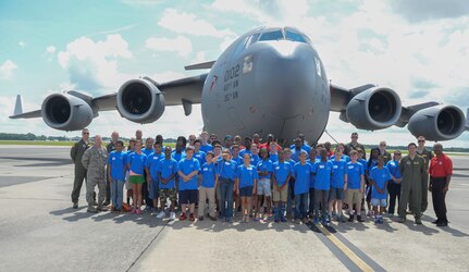 Thirty-eight students from the Take Flight! Aviation Camp, Tuskegee Airmen and C-17 Globemaster III crewmembers, pose for a group photo June 11, 2015, on the flight line at Joint Base Charleston, S.C.  The students began their day at JB Charleston where they attended a symposium at the 14th Airlift Squadron and later toured the C-17. Following lunch, they received a tour at the Boeing factory adjacent to the base. The visit introduces the students to potential careers in aviation as well as emphasizing the importance of education and pursuing goals. (U.S. Air Force photo/ 1st Lt. Alexandra Trobe)