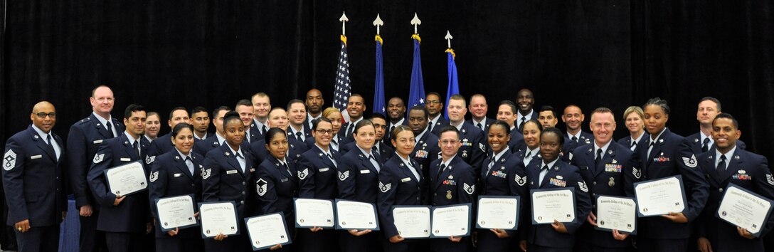 Community College of the Air Force graduates pose for a group photo immediately following a ceremony at Homestead Air Reserve Base, Fla. Team Homestead recognized 45 Airman for earning CCAF degrees  in a graduation ceremony June 14 in the Sam Johnson Fitness Center here. 