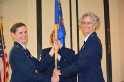 Lt. Col. Maureen Williams, 628th Aerospace Medicine Squadron commander, takes the guidon from Col. Margret Jones, 628th Medical Group commander during the squadron's change of command ceremony June 9, 2015 at the Charleston Club on Joint Base Charleston, S.C. Williams' previous assignment was at Offutt Air Force Base, Ne. Lt. Col. Ray Clydesdale, the outgoing squadron commander is headed to Ft. McNair in Washington, D.C. where he will attend the Eisenhower School for National Security and Resource Strategy.  (Courtesy photo / 628th AMDS)