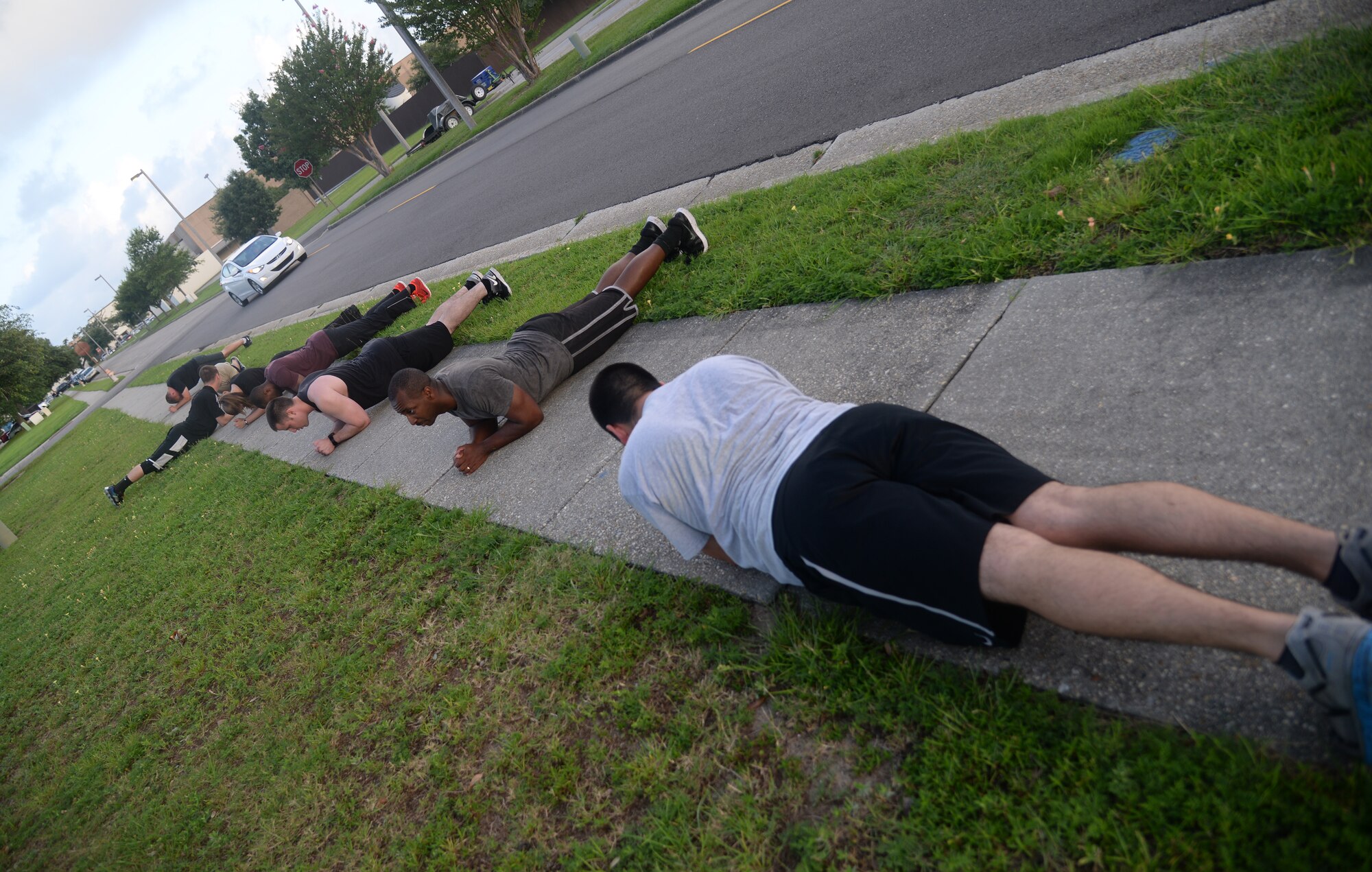 Members of the 81st Comptroller Squadron perform planks after running sprints at squadron physical training, June 16, 2015, Keesler Air Force Base, Miss. The 81st CPTS conducts PT three times a week to  build physical strength and foster squadron unity. (U.S. Air Force photo by Senior Airman Holly Mansfield)