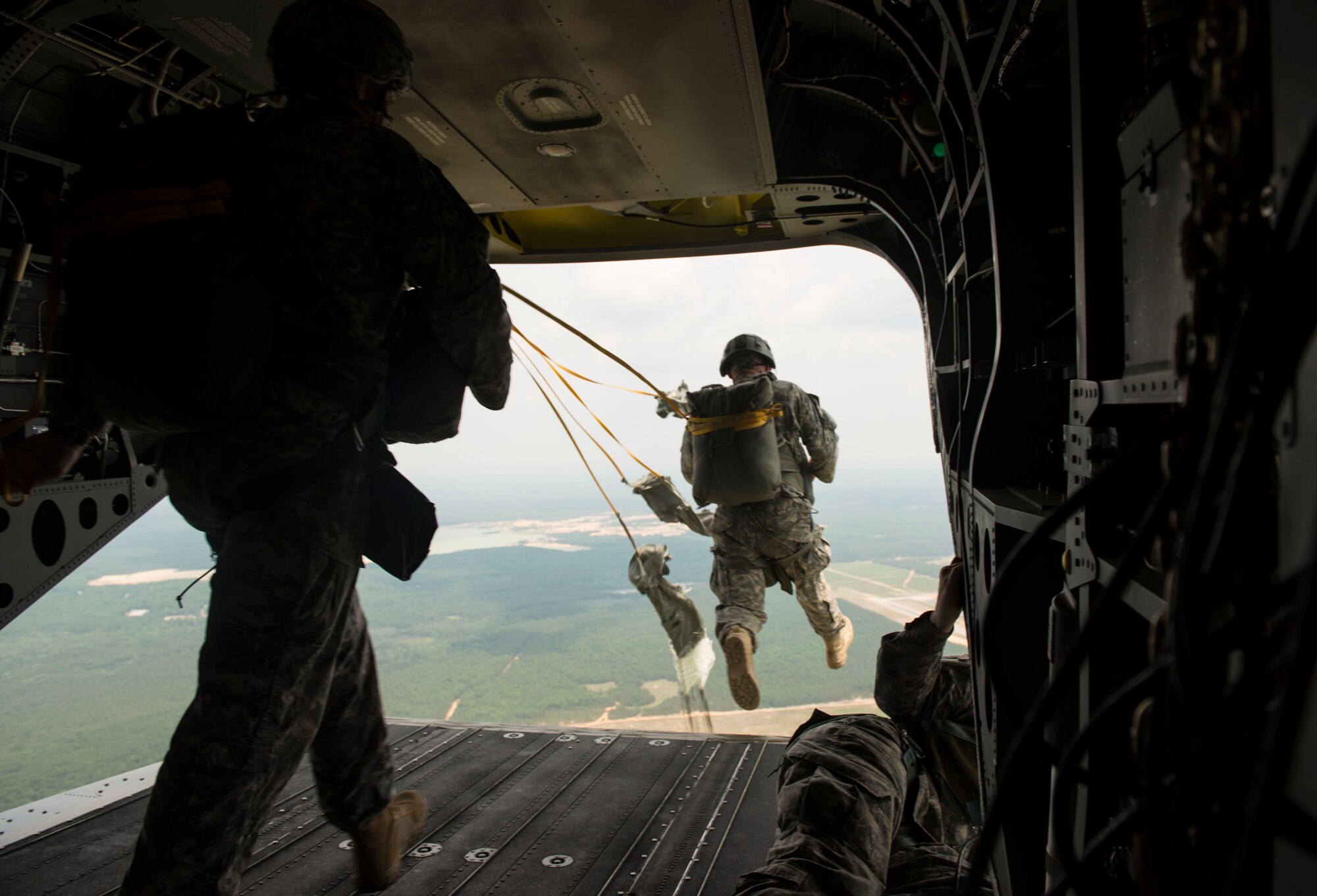 Members of the 404th Civil Affairs Battalion jump from the back of a CH-47 Chinook during training on Joint Base McGuire-Dix-Lakehurst, N.J. June 12, 2015. Capt. Jennifer Wertz, 404th CAB team leader,  also took time during training to re-commission after acceptance into the U.S. Army Nurse Corps. (U.S. Air Force photo by Airman 1st Class Joshua King)