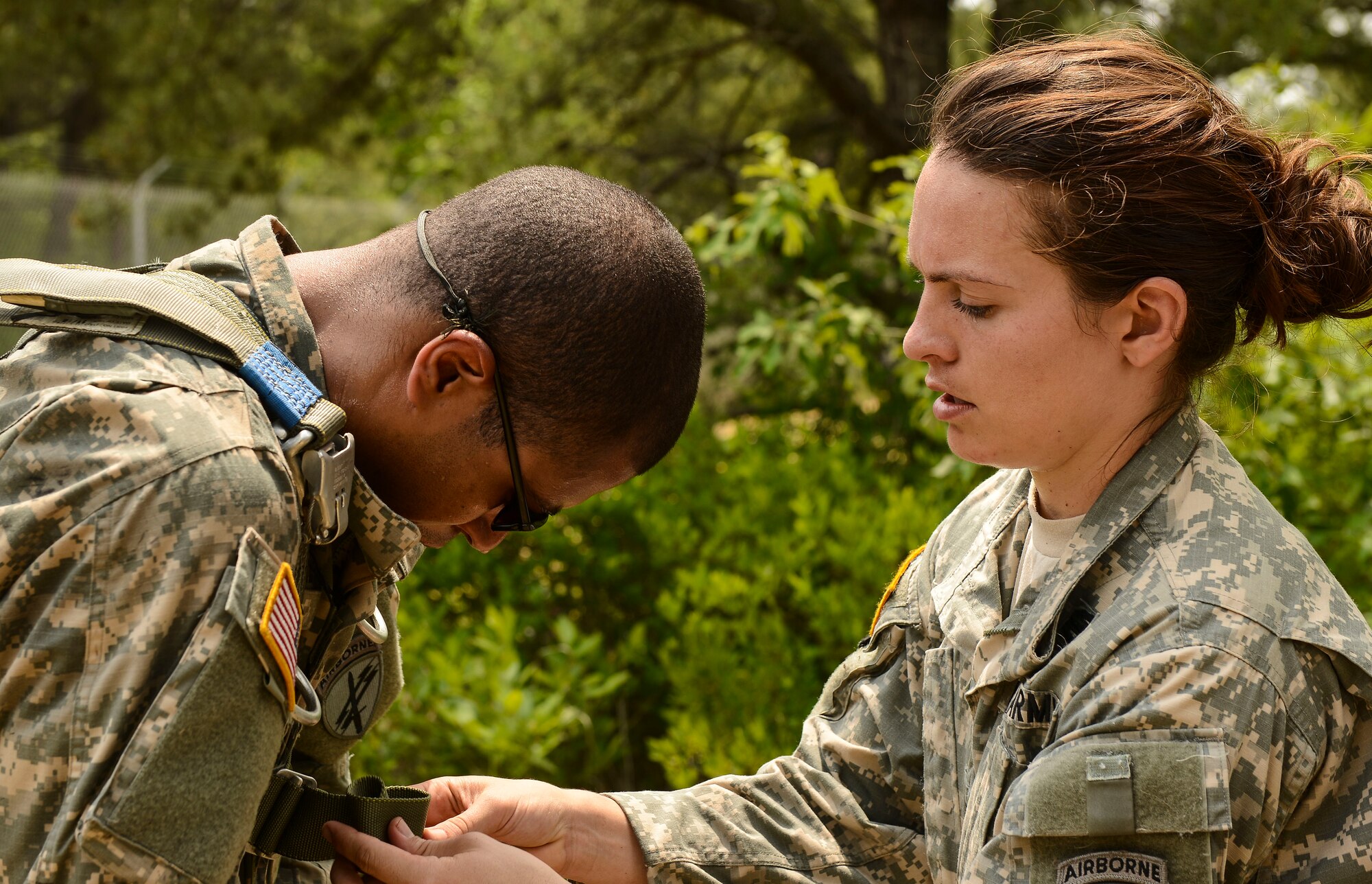 Capt. Jennifer Wertz, 404th Civil Affairs Battalion team leader, checks parachute rigging on a fellow Soldier before his jump on Joint Base McGuire-Dix-Lakehurst, N.J. June 12, 2015. The 404th CAB is a Reserve Airborne unit stationed on JB MDL.  (U.S. Air Force photo by Airman 1st Class Joshua King)