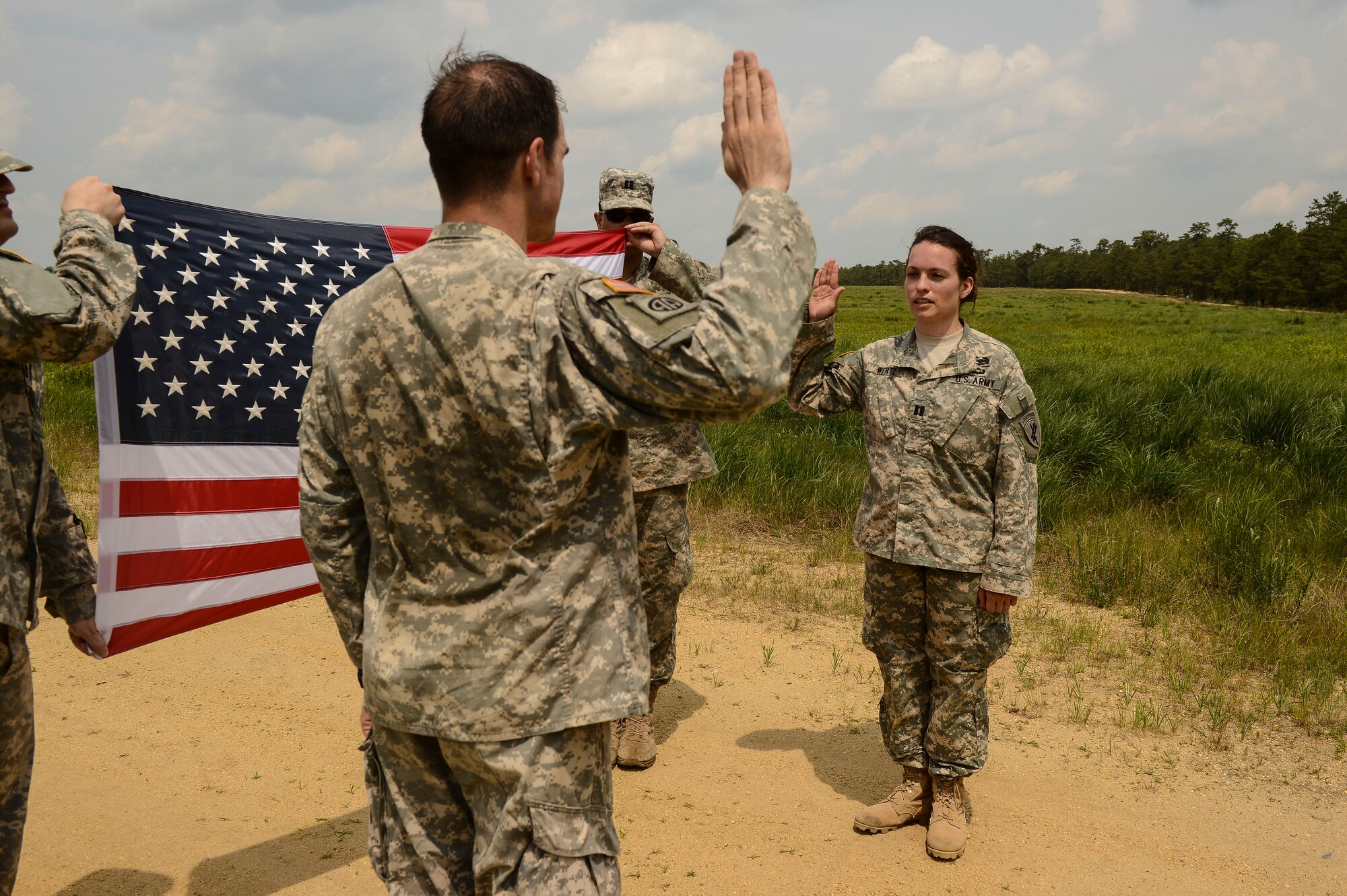 Capt. Jennifer Wertz, 404th Civil Affairs Battalion team leader, swears a re-commissioning oath, issued by her husband Maj. Anthony Wertz, Special Warfare Education Group, Airborne, Fort Bragg, N.C., on Joint Base McGuire-Dix-Lakehurst, N.J. June 12, 2015. Captain Wertz will complete her nursing degree at Duke University, N.C. before becoming active duty as part of the Army Nurse Corps. (U.S. Air Force photo by Airman 1st Class Joshua King)
