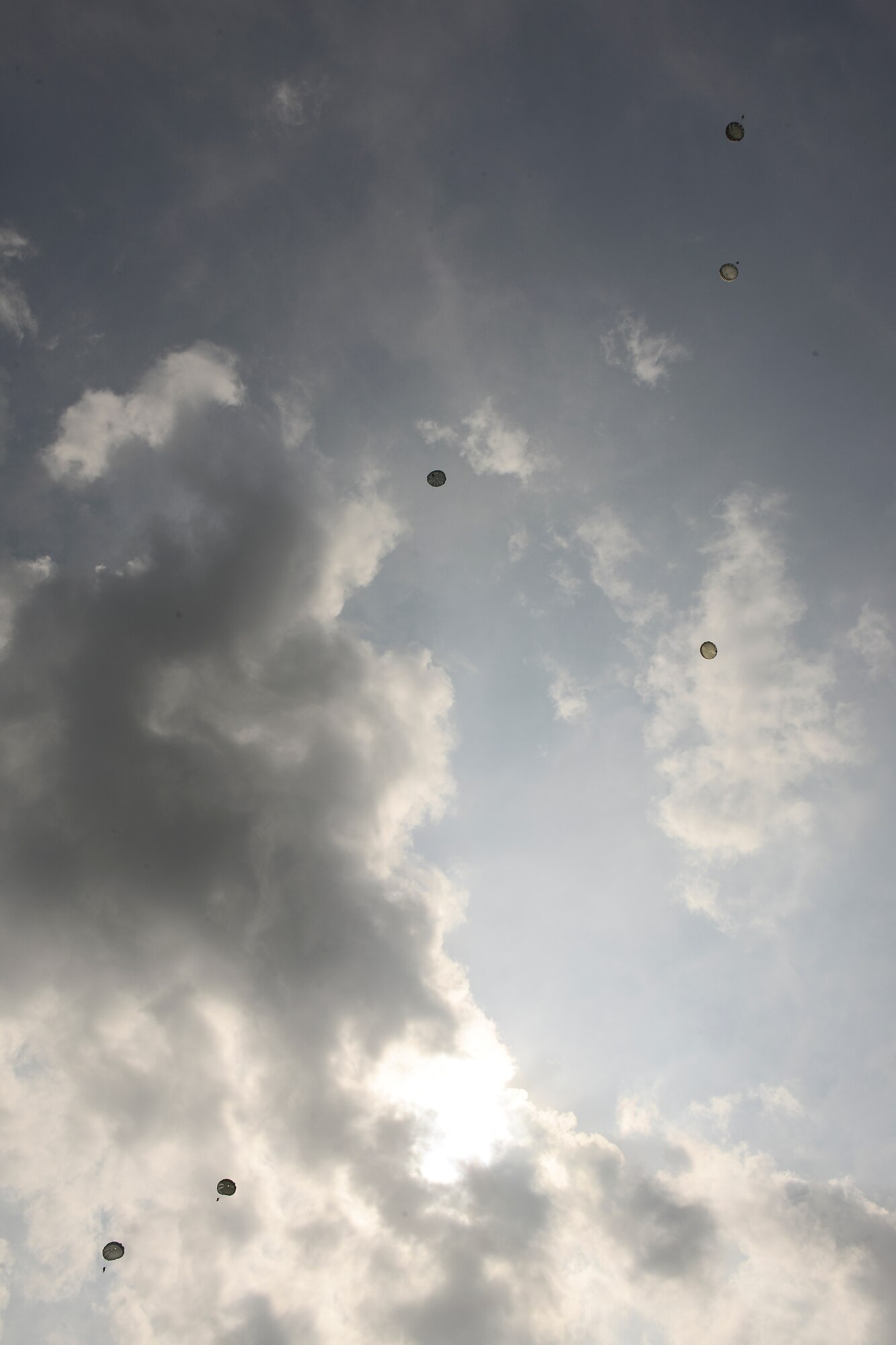 Members of the 404th Civil Affairs Battalion parachute to the ground after jumping out of a CH-47 Chinook over Joint Base McGuire-Dix-Lakehurst, N.J. June 12, 2015. The 404th CAB is a Reserve Airborne unit stationed on JB MDL. (U.S. Air Force photo by Airman 1st Class Joshua King)