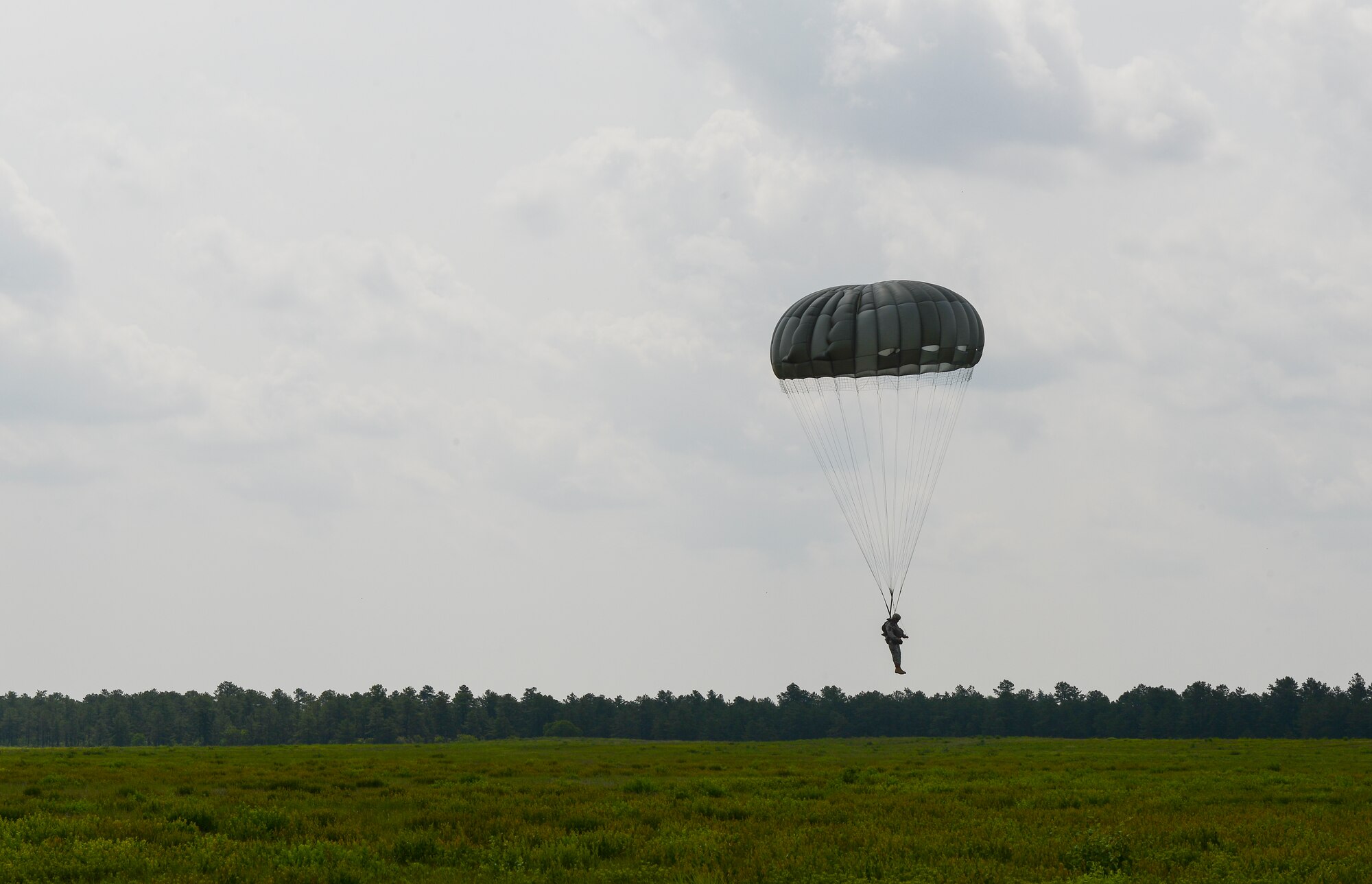 A Soldier of the 404th Civil Affairs Battalion parachute to the ground after jumping out of a CH-47 Chinook over Joint Base McGuire-Dix-Lakehurst, N.J. June 12, 2015. The 404th CAB is a Reserve Airborne unit stationed on JB MDL. (U.S. Air Force photo by Airman 1st Class Joshua King)