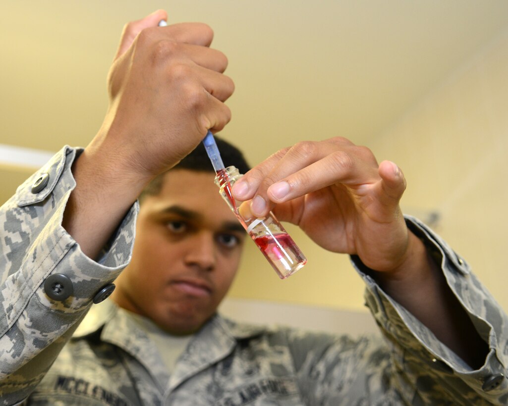 U.S. Air Force Airman Alex McClendon, 633rd Aerospace Medicine Squadron bioenvironmental engineering technician, adds a pH-testing solution to a tap water sample at Langley Air Force Base, Va., June 12, 2015. Bioenvironmental Airmen from the 633rd AMDS bring no less than 10 samples to the laboratory monthly, as to ensure the water is free from coliform bacteria. (U.S. Air Force photo by Airman 1st Class Devin S. Michaels/Released)