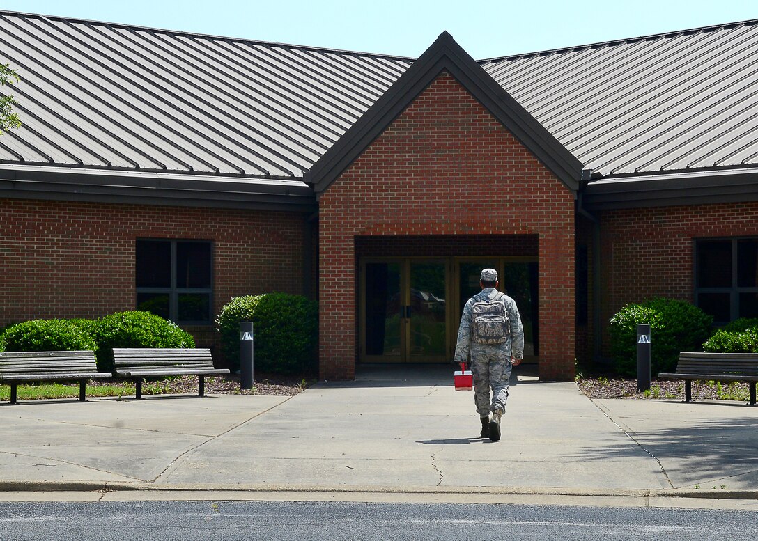 U.S. Air Force Airman Alex McClendon, 633rd Aerospace Medicine Squadron bioenvironmental engineering technician, walks toward the education center at Langley Air Force Base, Va., June 12, 2015. The education center and other buildings on base get their tap water checked monthly for continued compliance with Air Force Instruction for drinkable water. (U.S. Air Force photo by Airman 1st Class Devin S. Michaels/Released)