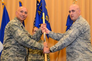 U.S. Air Force Col. Erik Rundquist, Air Combat Command security forces chief, passes the organization's guidon to Brig. Gen. Kenneth Lapierre, ACC Logistics, Engineering and Force Protection director, during the ACC Installations and Mission Support Directorate’s inactivation ceremony at Langley Air Force Base, Va., June 16, 2015. As part of the inactivation of the ACC Installations and Mission Support Directorate, security forces will now fall under the Logistics, Engineering and Force Protection Directorate. The passing of the guidon to Brig. Gen. Lapierre symbolizes the cessation of the ACC Installations and Mission Support Directorate. (U.S. Air Force photo by Airman 1st Class Devin S. Michaels/Released) 