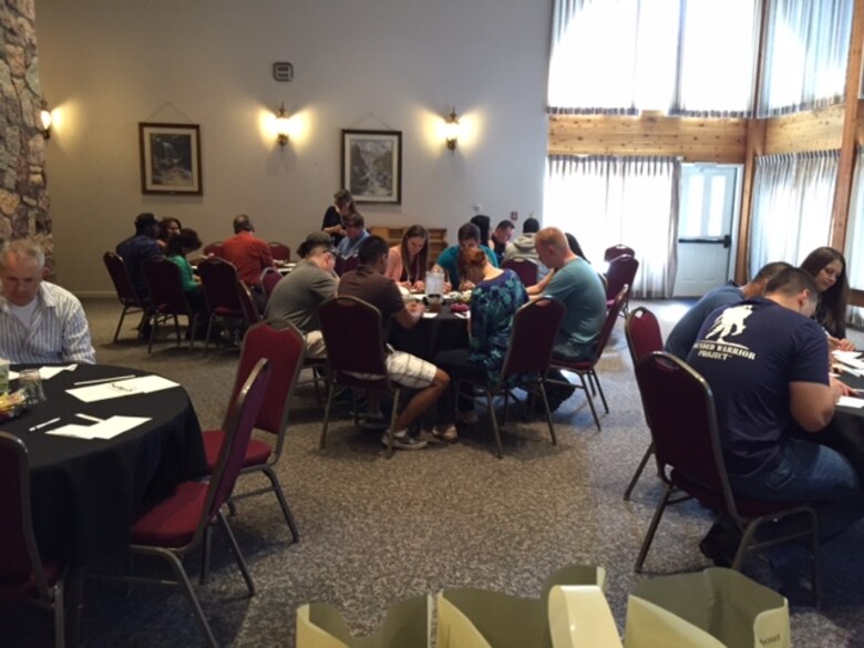 Couples work on a relationship project during the Marriage Care Weekend Retreat, sponsored by the 50th Space Wing Chaplain’s office, Saturday, June 17, 2015, at Glen Eyrie Castle, Colorado Springs, Colorado. The project is designed to help couples learn about and discuss each other's family background. (Courtesy Photo)