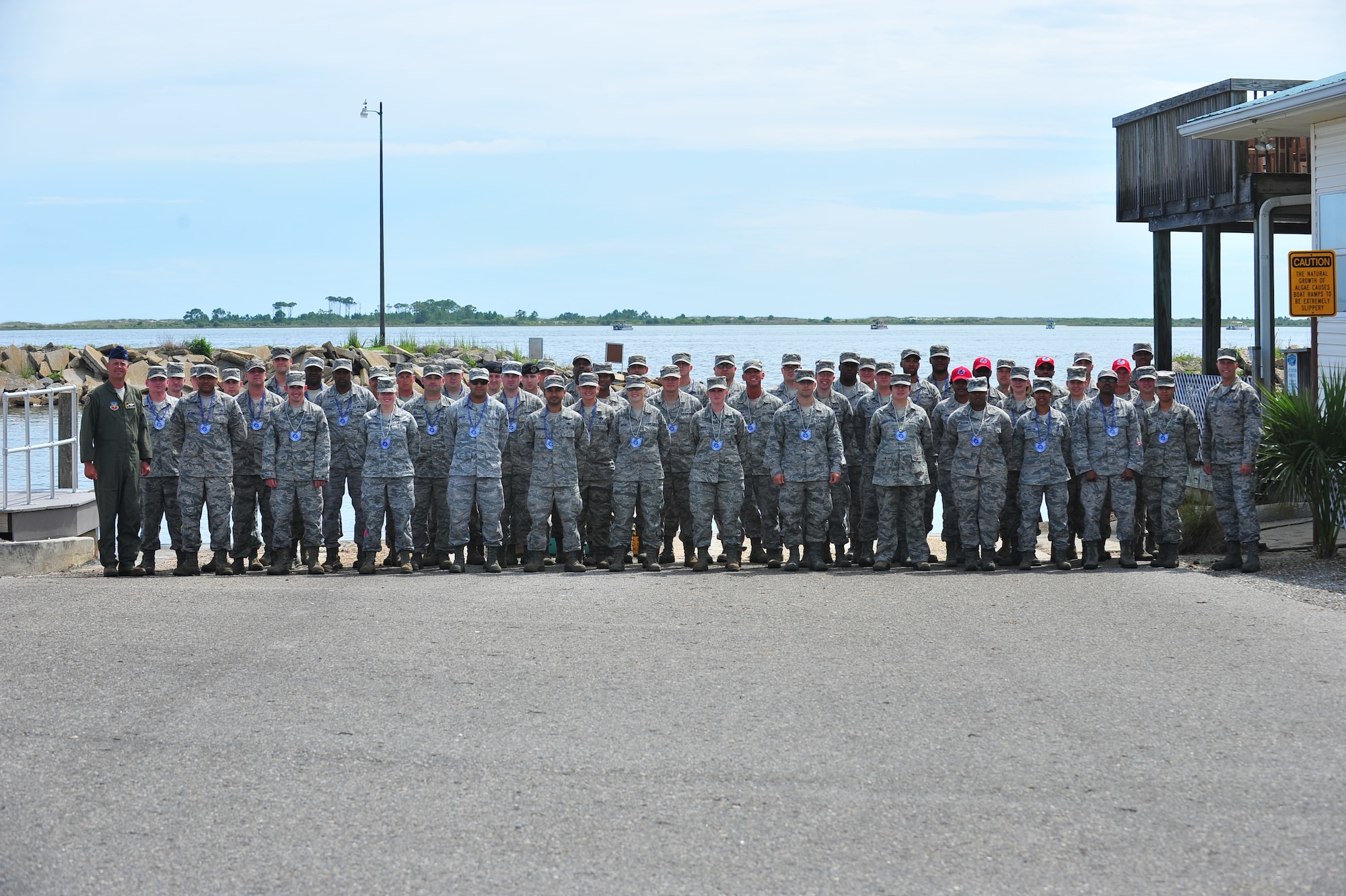The new Team Tyndall technical sergeant selects take a group photo with 325th Fighter Wing leadership June 10 at the base Marina. Congratulations to all the Airmen who made it. (U.S. Air Force photo by Airman 1st Class Dustin Mullen/Released)
