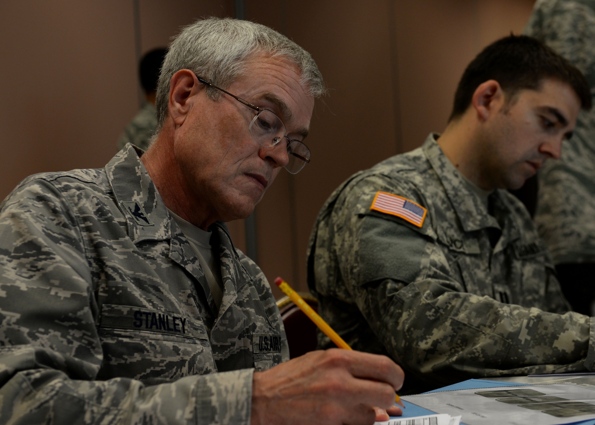 U.S. Air Force Col. Corey Stanley, 86th Dental Squadron chief of periodontics, records information off an x-ray case study during the oral education conference, June 12, 2015, at Aviano Air Base, Italy. Attendees were split into teams and provided different pieces of information to see if each team could come to the correct conclusion. Aviano’s location provided a money-saving option for the conference compared to hosting the conference in the United States. (Air Force photo by Airman 1st Class Cary Smith/Released) 