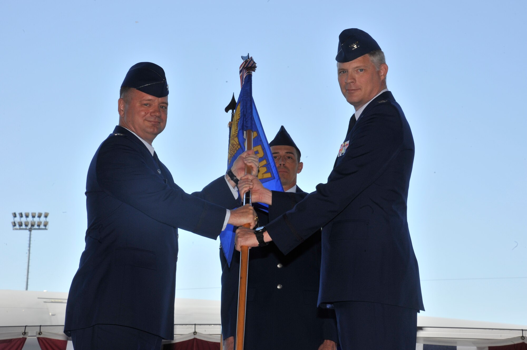 Col. Brian McDaniel, 92nd Air Refueling Wing commander, presents the 92nd Maintenance Group guidon to Col. Alan Hart, the new 92nd MXG commander, June 16, 2015, at Fairchild Air Force Base, Wash. Previously, Hart was the Director of Logistics, Installations and Mission Support, at Davis-Mothan AFB, AZ. (U.S. Air Force photo/Airman 1st Class Taylor Bourgeous)