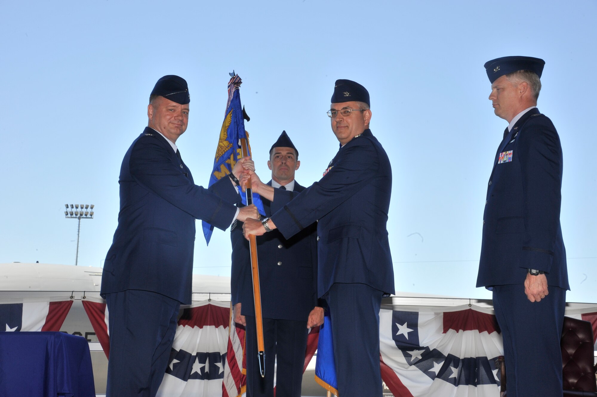 Col. Brian McDaniel, 92nd Air Refueling Wing commander, receives the 92nd Maintenance Group guidon from Col. Ken Timko, former 92nd MXG commander, June 16, 2015, at Fairchild Air Force Base, Wash. Timko relinquished his position as the 92nd MXG commander in the change of command ceremony. The change of command is an official, formal and brief ceremony that is the military’s way of bestowing command responsibility of a unit to an officer. (U.S. Air Force photo/Airman 1st Class Taylor Bourgeous)