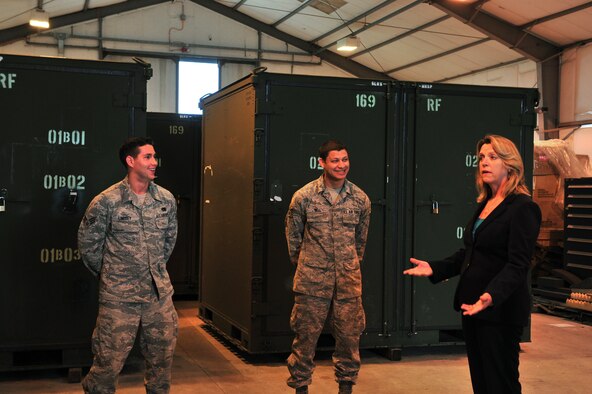 Secretary of the Air Force Deborah Lee James tells a joke to Senior Airman John Lindsey, 5th Aircraft Maintenance Squadron combat oriented supply operations technician, and Senior Airman Jeffery Bell, 5th Logistics Readiness Squadron supply material management technician, during her visit to Royal Air Force Fairford, England, June 17, 2015. Over 300 military personnel from five U.S. bases deployed to RAF Fairford in support of a bomber deployment which trained personnel in hot-pit refueling and engine-running crew changes on B-2 Spirits and supported B-52 Stratofortress missions in the multi-national exercises BALTOPS 15 and Saber Strike 15. James visited the base to see how the Airmen completed their mission in a forward-deployed location. (U.S. Air Force photo/Senior Airman Malia Jenkins)