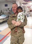 Chaplain (Capt.) Keith Manry cares for a child in the Intensive Care Unit at the Craig Joint Theater Hospital, Bagram Airfield, Afghanistan during a 2014 deployment. The child belonged to a patient who was undergoing surgery. Manry is assigned to the 341st Missile Wing at Malmstrom Air Force Base, Mont., and was recently awarded the Air Force Chaplain Corps Company Grade Officer Chaplain of the Year for 2014. (Courtesy photo)