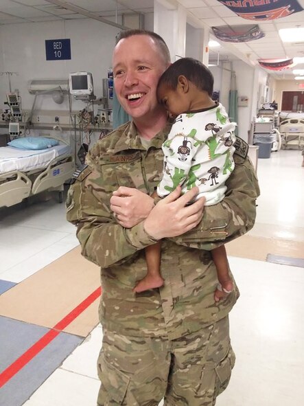 Chaplain (Capt.) Keith Manry cares for a child in the Intensive Care Unit at the Craig Joint Theater Hospital, Bagram Airfield, Afghanistan during a 2014 deployment. The child belonged to a patient who was undergoing surgery. Manry is assigned to the 341st Missile Wing at Malmstrom Air Force Base, Mont., and was recently awarded the Air Force Chaplain Corps Company Grade Officer Chaplain of the Year for 2014. (Courtesy photo)