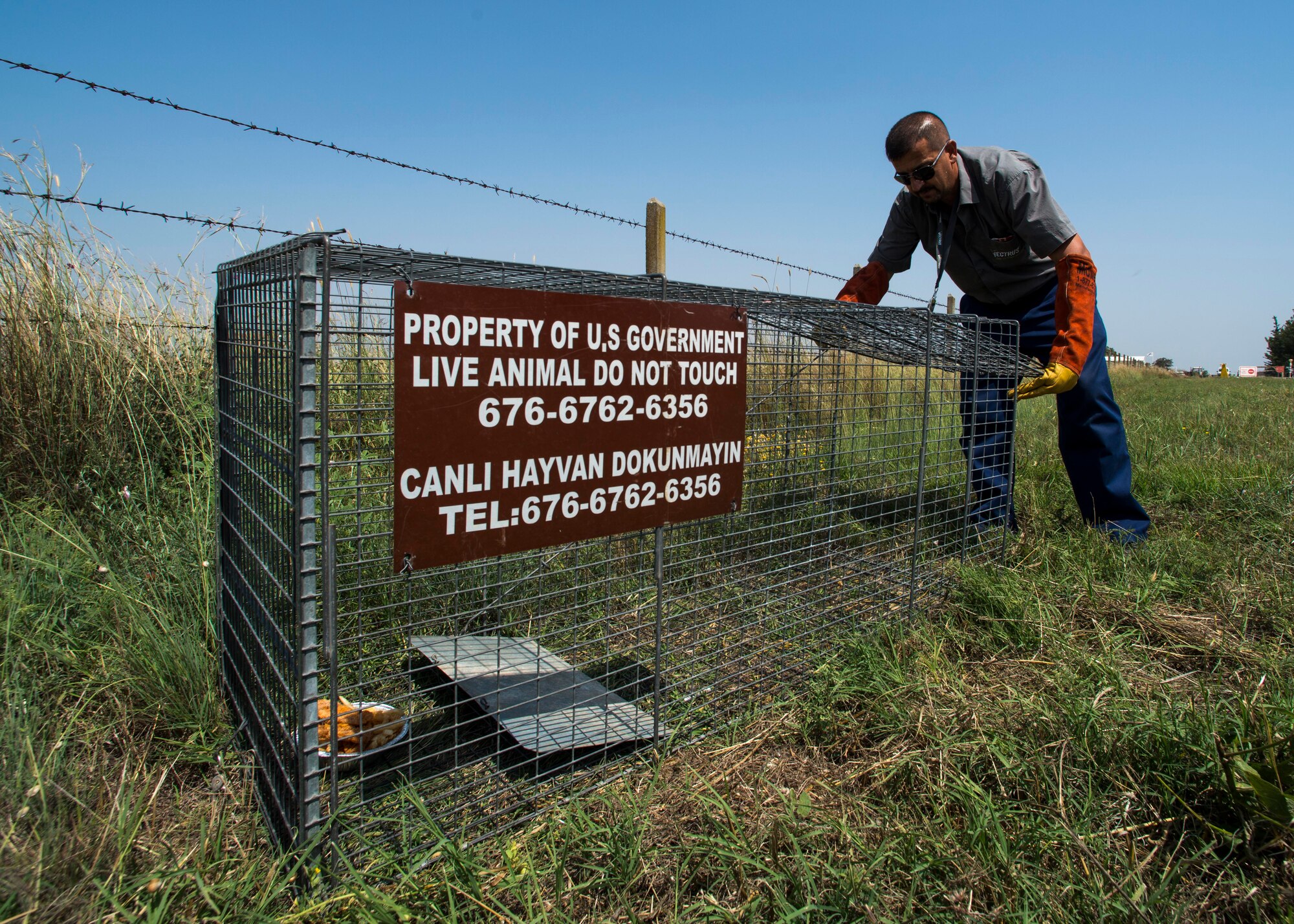 Battal Kocahan, 39th Civil Engineer Squadron pest management employee, sets up a trap to catch stray animals June 9, 2015, at Incirlik Air Base, Turkey. Some of the pesky insects and critters that call IAB their home are mosquitoes, ants, ticks, wasps, spiders, snakes and stray animals. (U.S. Air Force photo by Airman 1st Class Cory W. Bush/Released)