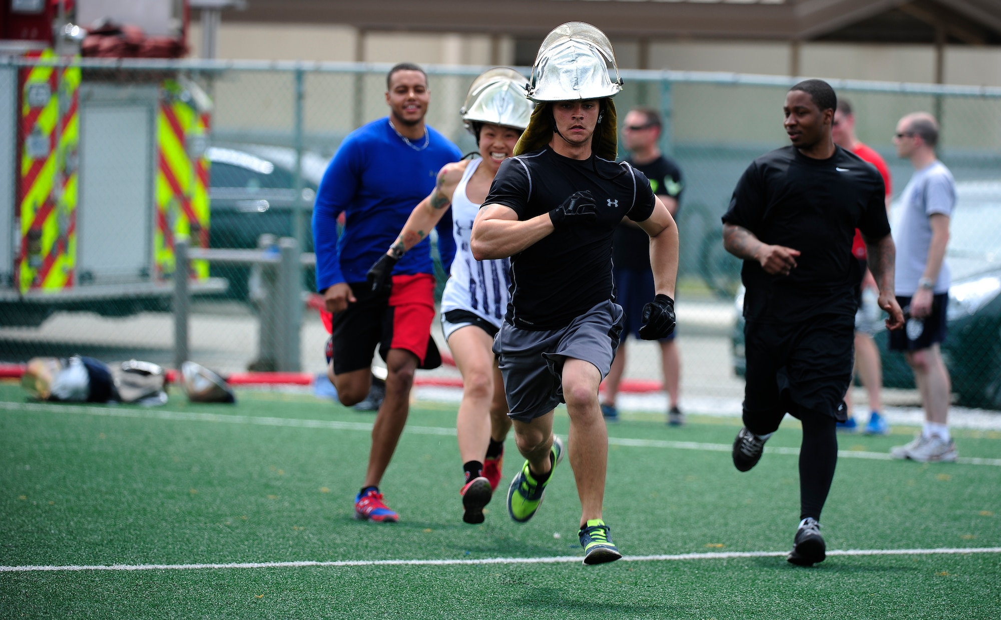 Airmen from the 8th Security Forces Squadron participate in a hose relay during a fire muster at the Wolf Pack Fitness Center on Kunsan Air Base, Republic of Korea, June 13, 2015. Six-member teams from across Wolf Pack, the Republic of Korea Air Force and Gunsan City Fire Department competed in five events to see which teams work the best as a unit. (U.S. Air Force photo by Staff Sgt. Nick Wilson/Released)
