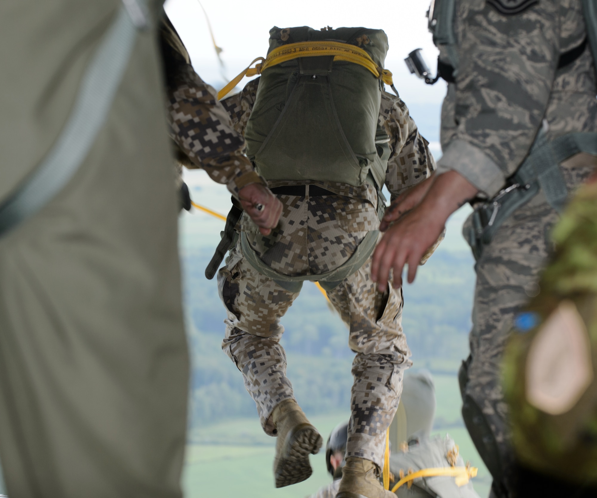 Latvian military members jump out of a U.S. Air Force C-130J Super Hercules during a combined jump June 15, 2015, Lielvarde Air Base, Latvia. More than 70 U.S. Air Force, U.S. Army and Latvian service members participated in a jump day to strengthen the bonds of allies and learn from each other during exercise Saber Strike 15. The exercise involves more than 6,000 service members from 14 nations participation all throughout Estonia, Latvia, Lithuania, and Poland to learn from each other and promote stability is the region. (U.S. Air Force photo/ Staff Sgt. Armando A. Schwier-Morales)