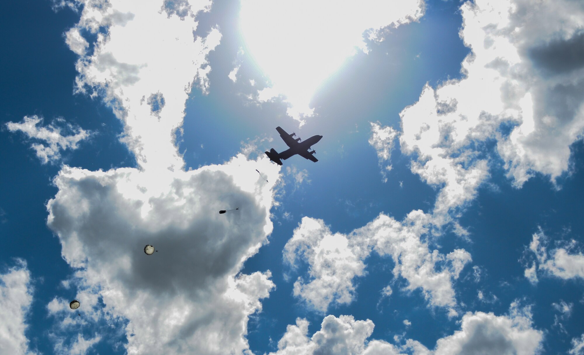 A 37th Airlift Squadron, Ramstein Air Base, Germany, C-130J Super Hercules drops multinational jumpers June 15, 2015, Lielvarde Air Base, Latvia. More than 70 U.S. Air Force, U.S. Army and Latvian service members participated in a multinational jump day to strengthen the bonds of allies and learn from each other during exercise Saber Strike 15. The exercise involves more than 6,000 service members from 14 nations participation all throughout Estonia, Latvia, Lithuania, and Poland to learn from each other and promote stability is the region. (U.S. Air Force photo/ Capt. Chase P. McFarland)