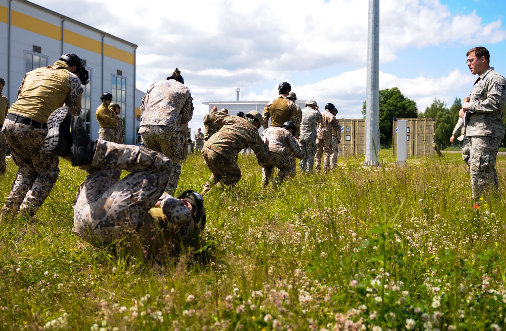 Tech Sgt. Timothy Gallagher, 435th Security Forces Squadron jumpmaster, leads landing drills prior to jumping with multinational forces June 15, 2015, Lielvarde Air Base, Latvia. More than 70 U.S. Air Force, U.S. Army and Latvian service members participated in a multinational jump day to strengthen the bonds of allies and learn from each other during exercise Saber Strike 15. The exercise involves more than 6,000 service members from 14 nations participation all throughout Estonia, Latvia, Lithuania, and Poland to learn from each other and promote stability is the region. (U.S. Air Force photo/ Capt. Chase P. McFarland)
