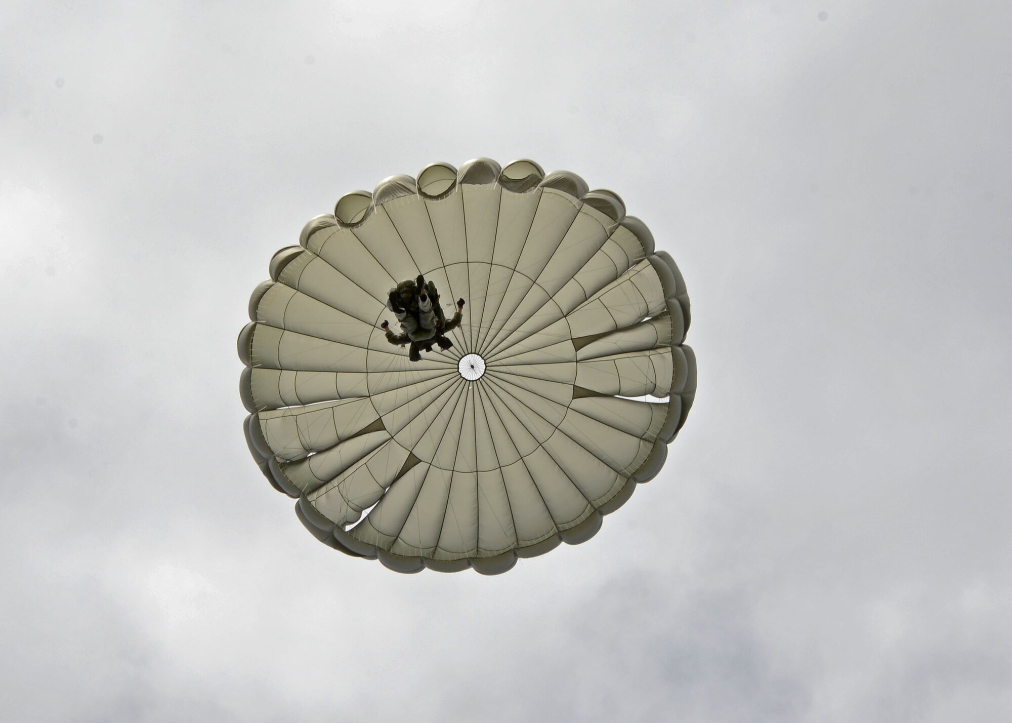 A security forces Airman assigned to the 37th Airlift Squadron, Ramstein Air Base, Germany, parachutes from a C-130J Hercules aircraft during a training mission onto an airfield in Nurmsi, Estonia during Saber Strike 15, June 11, 2015. The Airman is part of a Contingency Response Group that secures and assesses an area for suitability as a landing strip for follow on aircraft. (Air National Guard photo/ Tech. Sgt. Christopher Schepers)