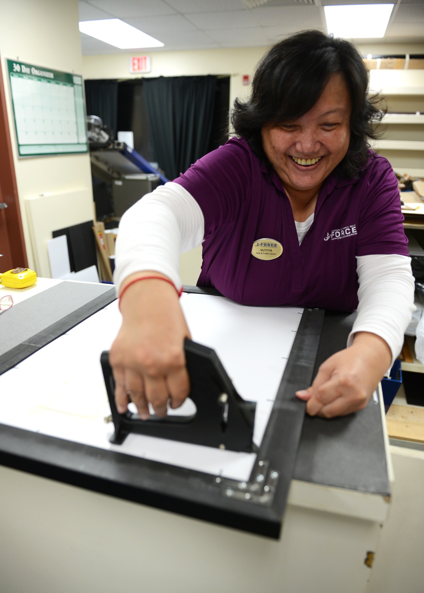 Nuttiya Jitsoontorn, 36th Force Support Squadron Arts and Crafts Center recreation assistant, works on a custom frame June 10, 2015, at Andersen Air Force Base, Guam. The Arts and Crafts Center provides engraving and framing services as well as a wide variety of classes for people of all ages. (U.S. Air Force photo by Airman 1st Class Arielle Vasquez/Released)