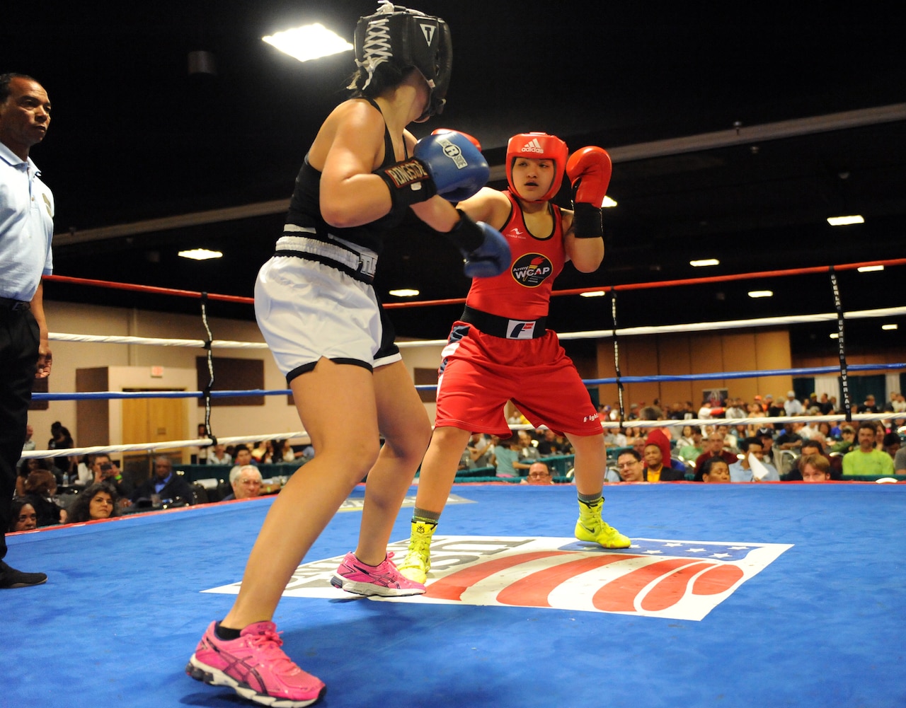 Army Pfc. Rianna Rios, in red, of Fort Carson, Colorado, fights Katina Melendrez in the women's open 132-pound division finale of the 2015 Colorado Golden Gloves Championships at the Crown Plaza Convention Center in Denver, March 27, 2015. Rios won by unanimous decision. U.S. Army photo by Tim Hipps