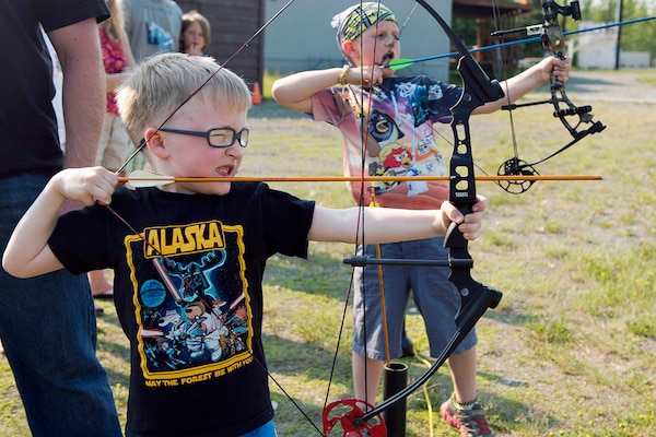 Sawyer Condrey (foreground), and Cj Willett take aim at the target during an archery class at the Skeet, Trap and Archery Range on Joint Base Elmendorf-Richardson, Alaska, June 15, 2015. (U.S. Air Force photo/Staff Sgt. Sheila deVera)