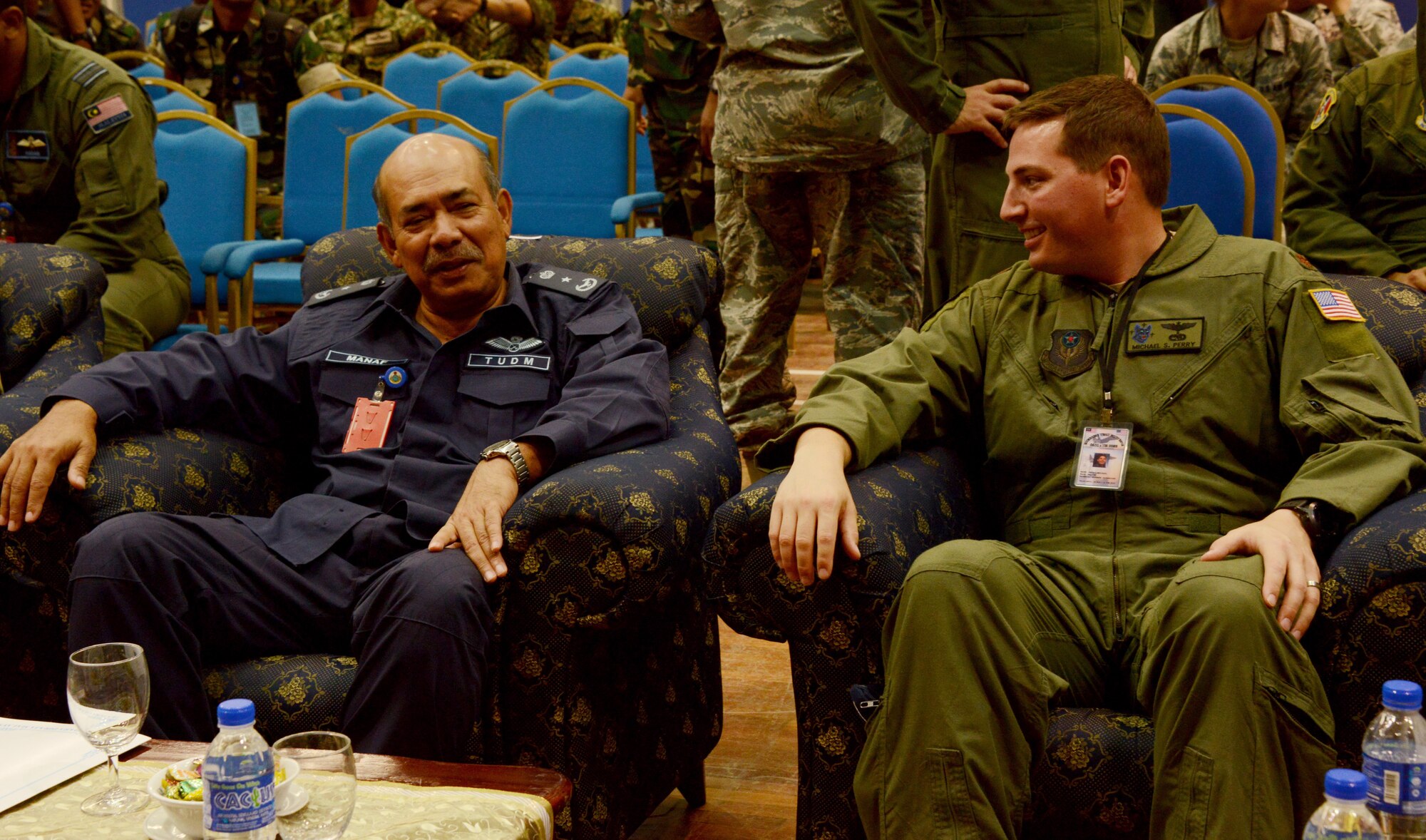 From left, Royal Malaysian Air Force Brig. Gen. Dato Abdul Manaf,  Subang Air Base commander, and U.S. Air Force Maj. Michael S. Perry, Exercise Teak Mint mission commander and an evaluator pilot from the 17th Special Operations Squadron, speak during the opening ceremony held May 30, 2015 at Subang Air Base, Malaysia. The 353rd Special Operations Group, from Kadena Air Base, Japan, along with the 36th Airlift Squadron, from Yokota Air Base, Japan, are participating in Joint Chiefs of Staff Exercise Teak Mint with the Royal Malaysian Air Force, a multinational and bilateral training used to enhance capabilities and capacities between the two countries.  