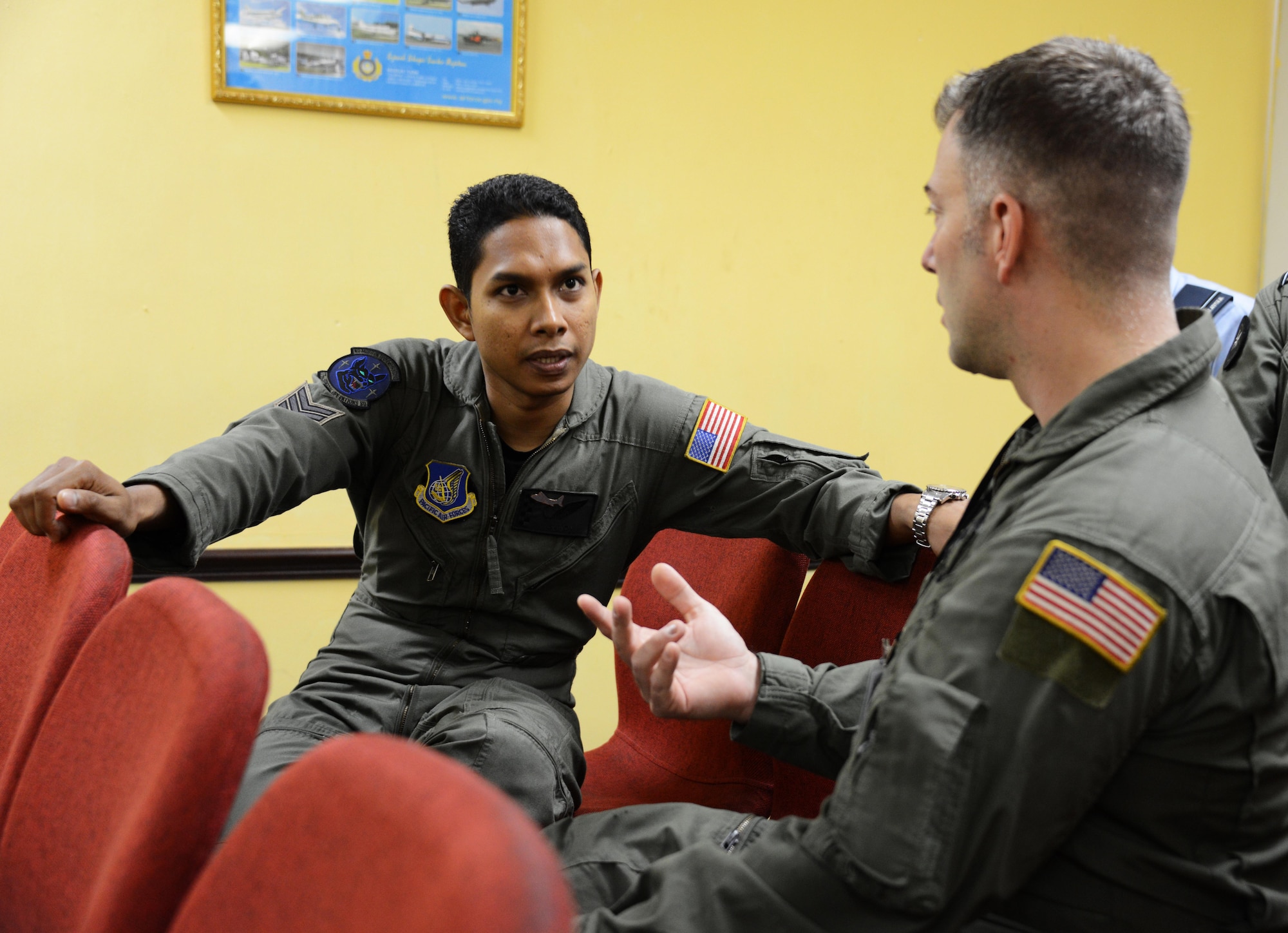 On right, U.S. Air Force Tech. Sgt. Ryan Moore, an MC-130J Commando II loadmaster from the 17th Special Operations Squadron, talks with a loadmaster from the Royal Malaysia Air Force during the night vision goggle operations focus exchange June 2, 2015 at Subang Air Base in Malaysia.  The class was held to help familiarize crews with the use of night vision operations and was conducted during Joint Chiefs of Staff Exercise Teak Mint.  (U.S. Air Force photo by Tech. Sgt. Kristine Dreyer)