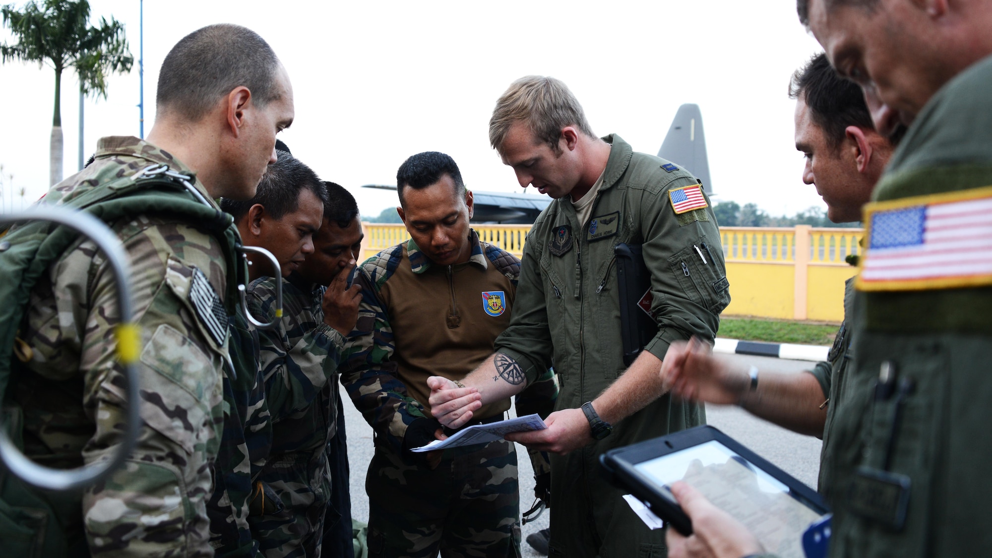 U.S. Air Force Capt. Charles Hobbs, a navigator at the 17th Special Operations Squadron, briefs the jumpmasters from the Royal Malaysian Army June 10, 2015 at Kuantan Air Base, Malaysia.  The crew from the 17th SOS conducted High Altitude Low Opening personnel drops with U.S. and Royal Malaysian Army jumpers during the Joint Combined Exchange Training/Field Training Exercise that was conducted at the end of Exercise Teak Mint.  Exercise Teak Mint is a multinational training exercise used to enhance capabilities and capacities between the two countries.  (U.S. Air Force photo by Tech. Sgt. Kristine Dreyer)