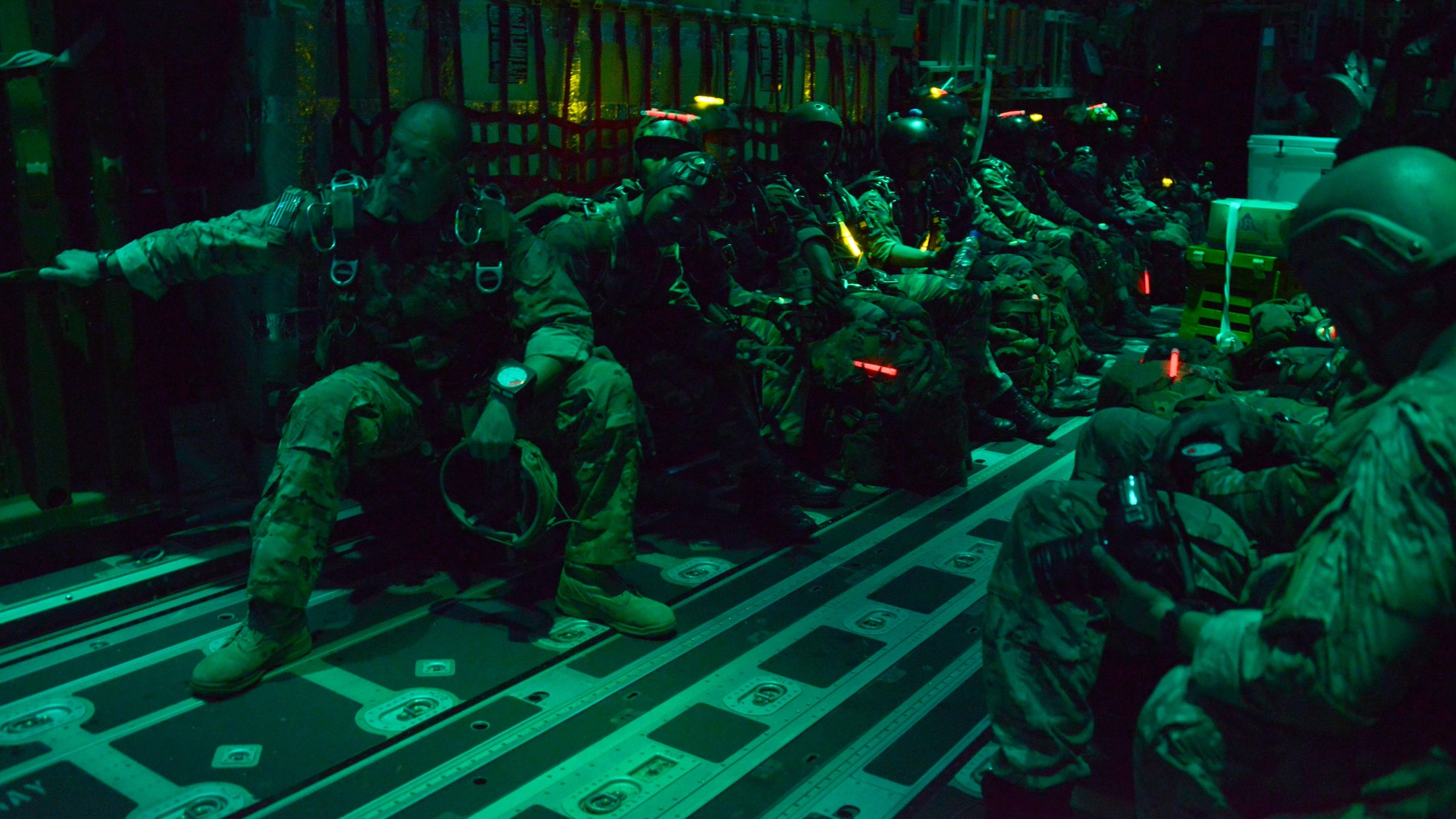 U.S. and Royal Malaysian Army jumpers wait to conduct night High Altitude Low Altitude jumps on board an MC-130J from the 17th Special Operations Squadron June 10, 2015 near Kuantan, Malaysia. The night HALO jumps were part of the Joint Combined Exchange Training/Field Training Exercise that was conducted at the end of Exercise Teak Mint.  Exercise Teak Mint is a multinational training exercise used to enhance capabilities and capacities between the two countries.  (U.S. Air Force photo by Tech. Sgt. Kristine Dreyer)